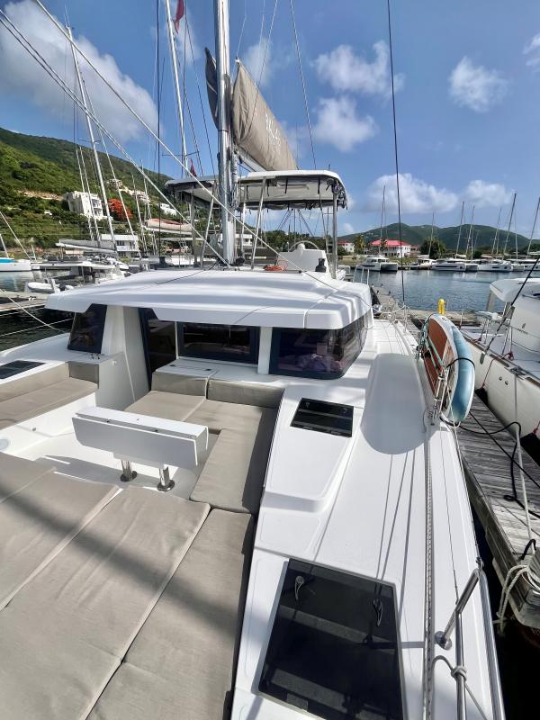 2023 Bali 4.6 catamaran docked at marina, featuring spacious deck and modern design.