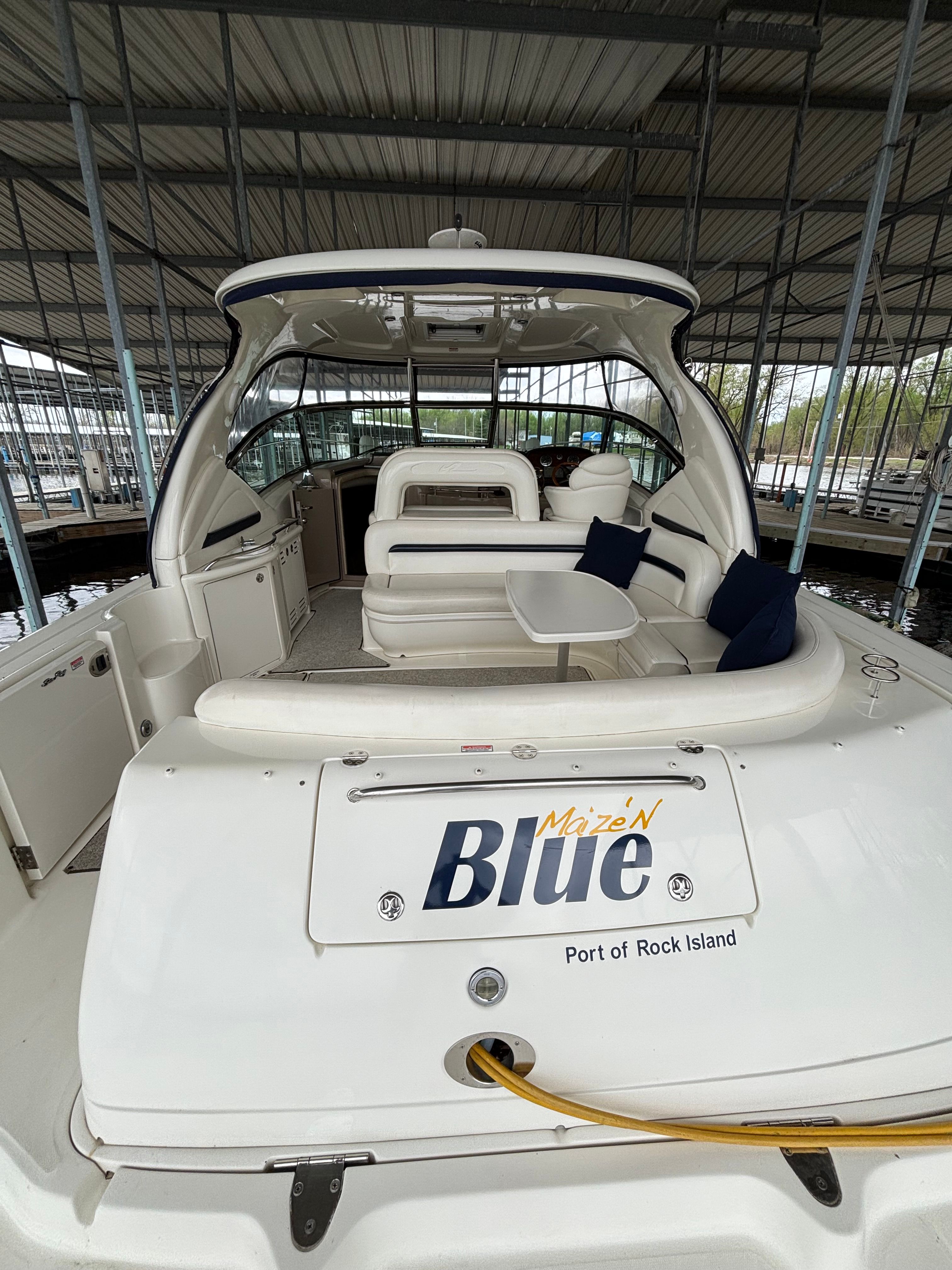 2004 Sea Ray 420 Sundancer yacht docked at marina.
