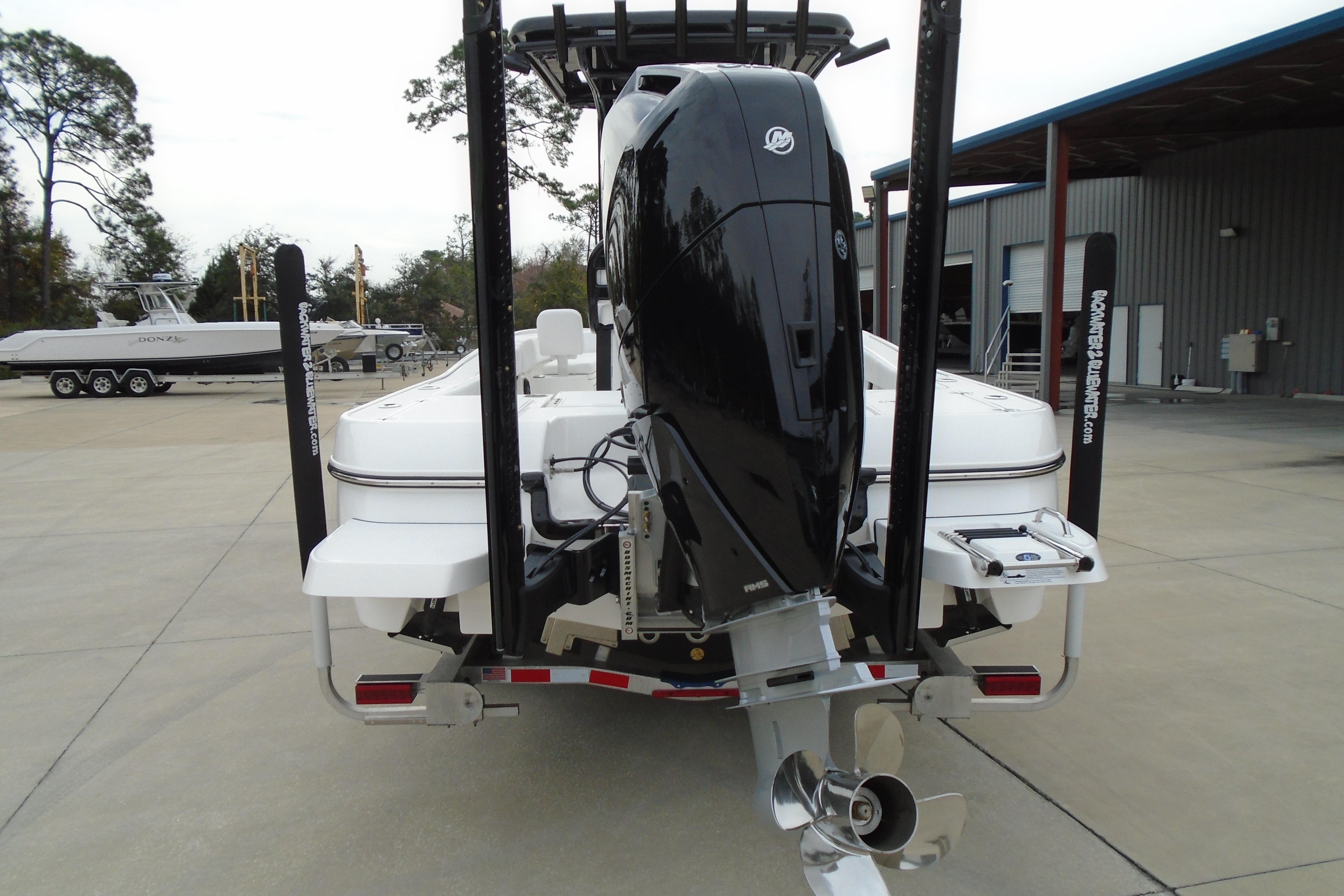 2026 Caymas 26 HB boat with powerful outboard motor, parked on a trailer.