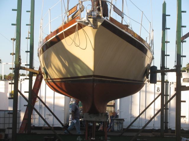 A boat is being serviced on a dry dock.