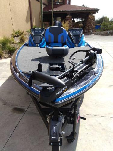 2025 Nitro Z19 boat with Minn Kota motor, parked outdoors.