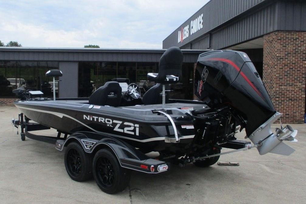 2026 Tracker Pro Guide V-16 WT boat, parked outside a dealership, featuring sleek design and powerful engine.