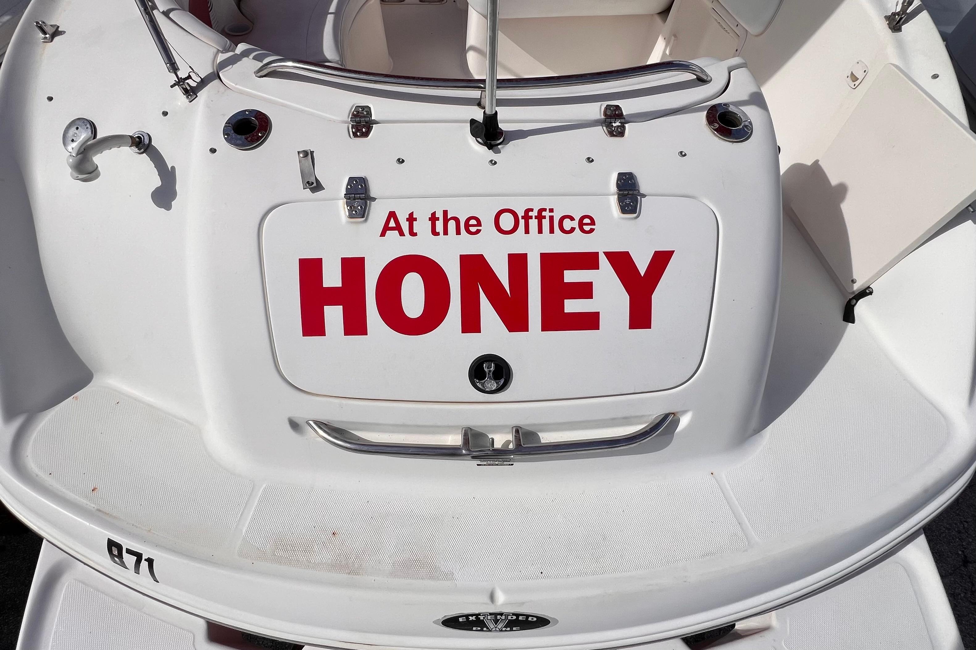 2002 Chaparral 232 Sunesta boat with "At the Office HONEY" sign on the back.