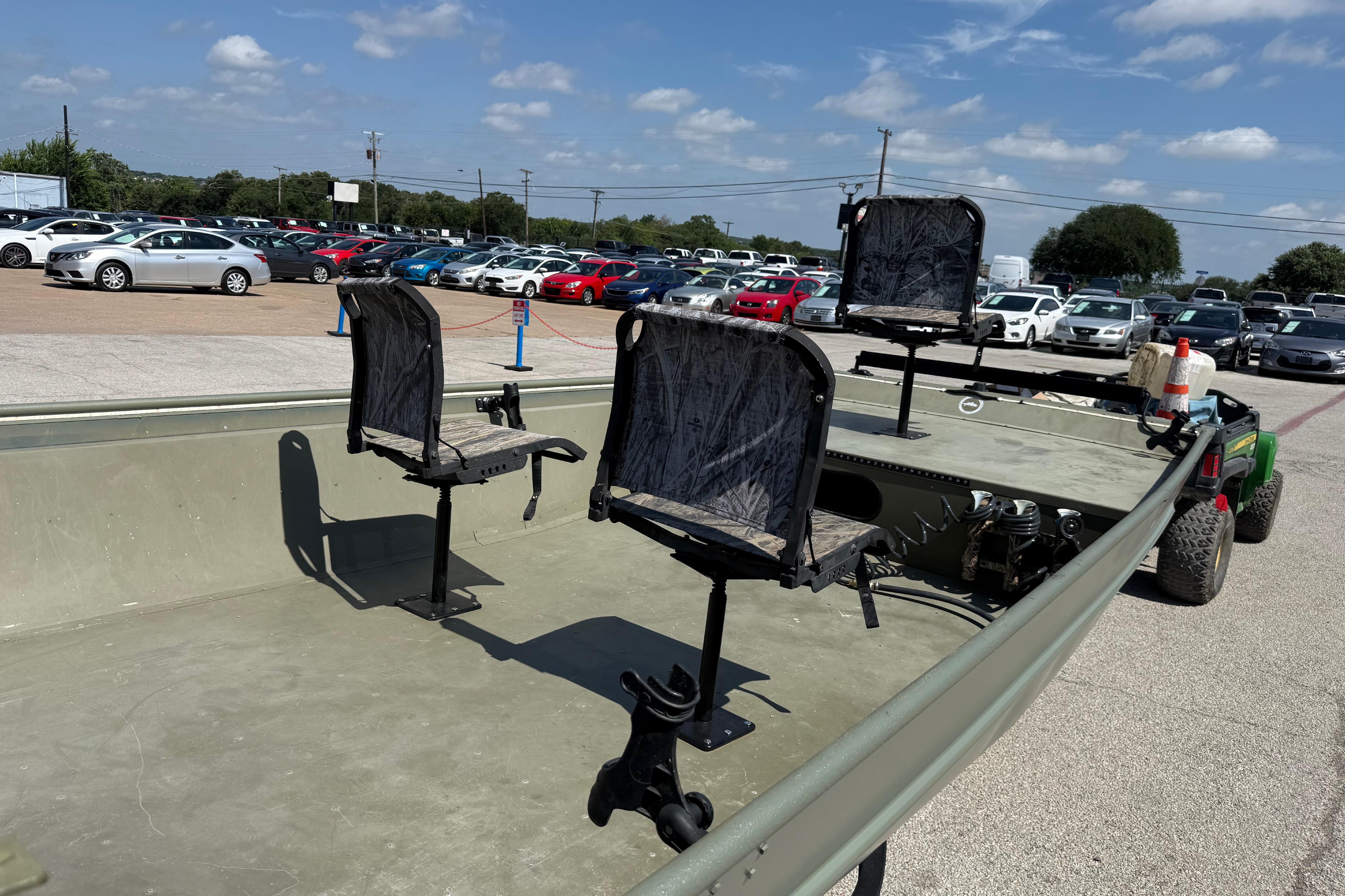The image shows a 2020 Lowe Roughneck 2070 Big River boat with three seats on a parking lot.