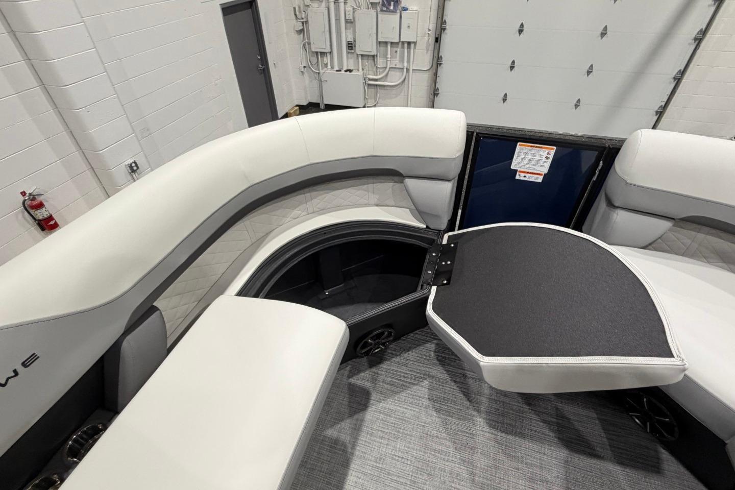 Interior of 2026 Lowe SS 230 WT boat with open storage compartment.