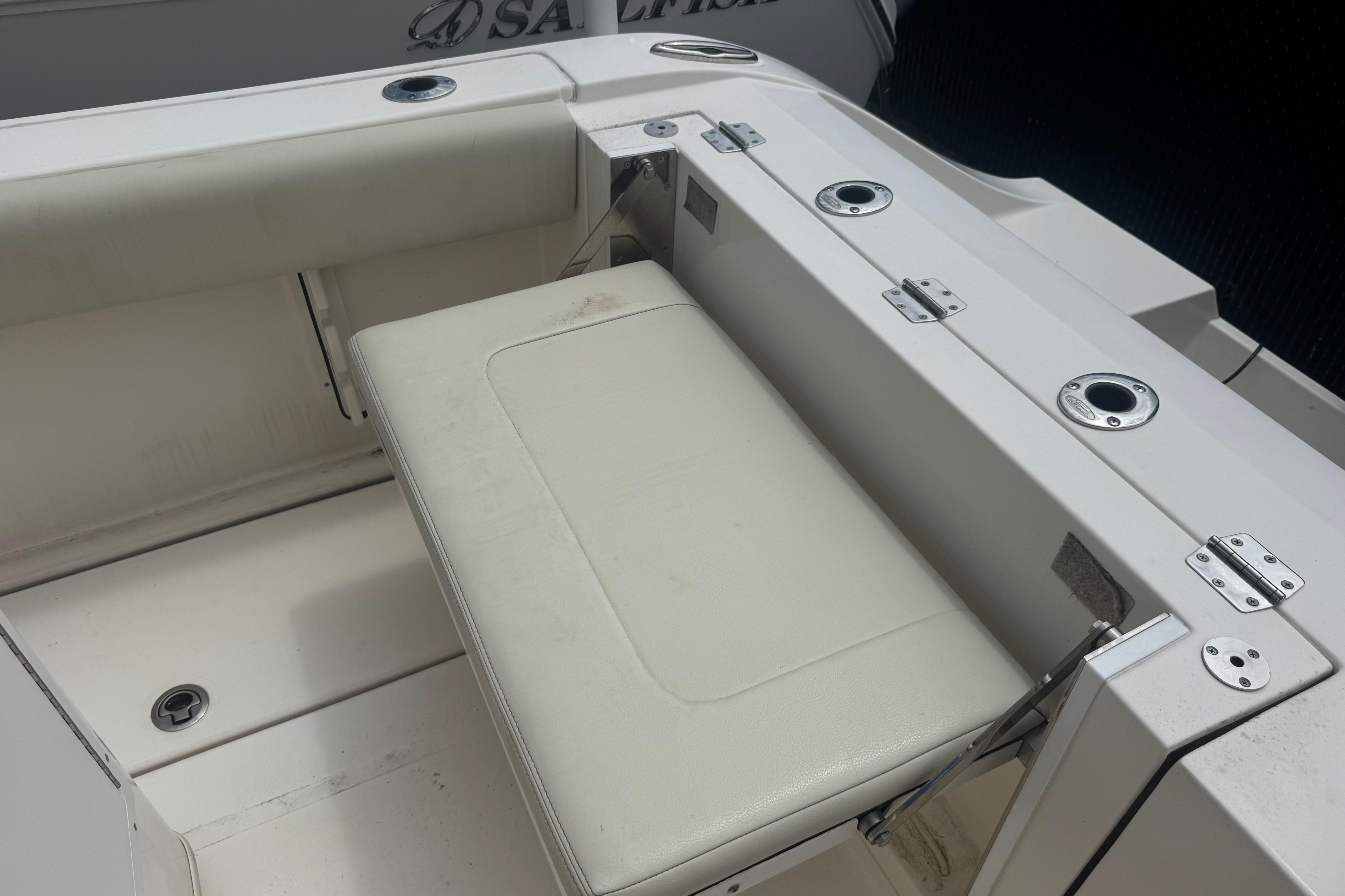 2022 Cobia 237 Center Console boat with white seating and rod holders.