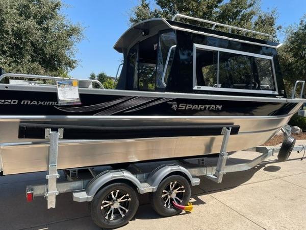 2024 Spartan 220 Maximus boat on trailer, sleek design, black and silver finish.