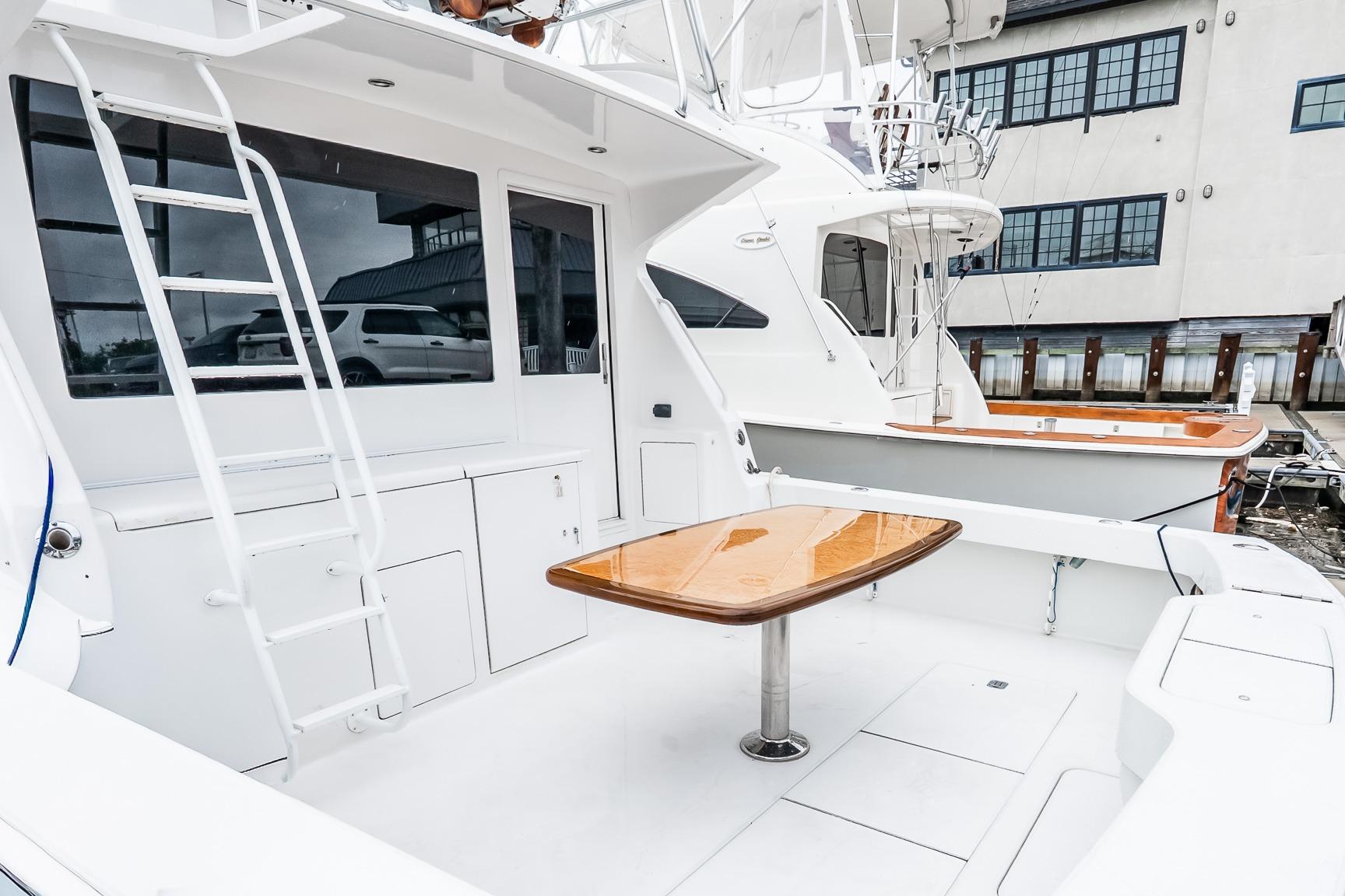 2000 Viking 50' Convertible yacht with sleek deck and polished wood table.