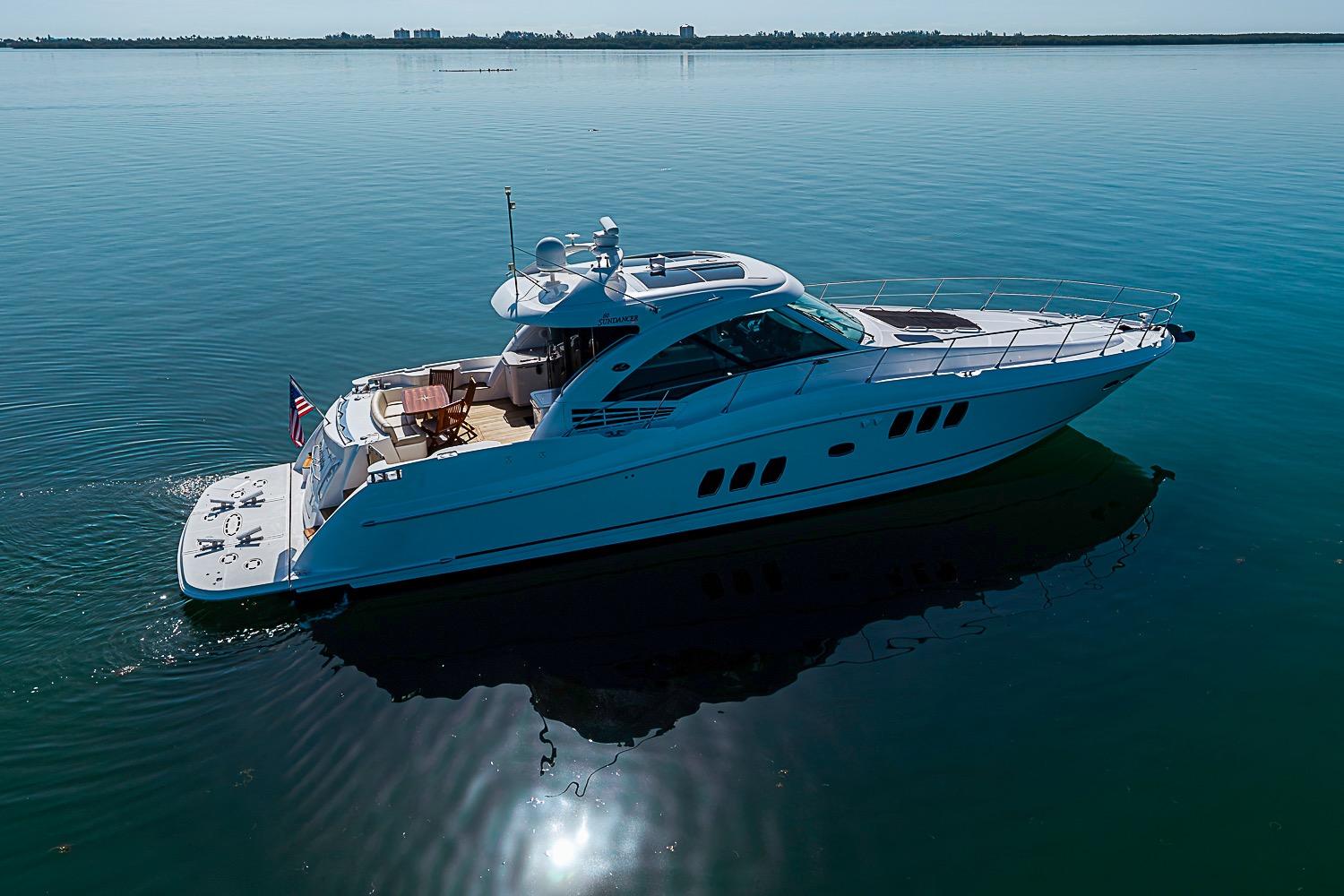 2008 Sea Ray 60 Sundancer yacht cruising on calm waters under clear skies.