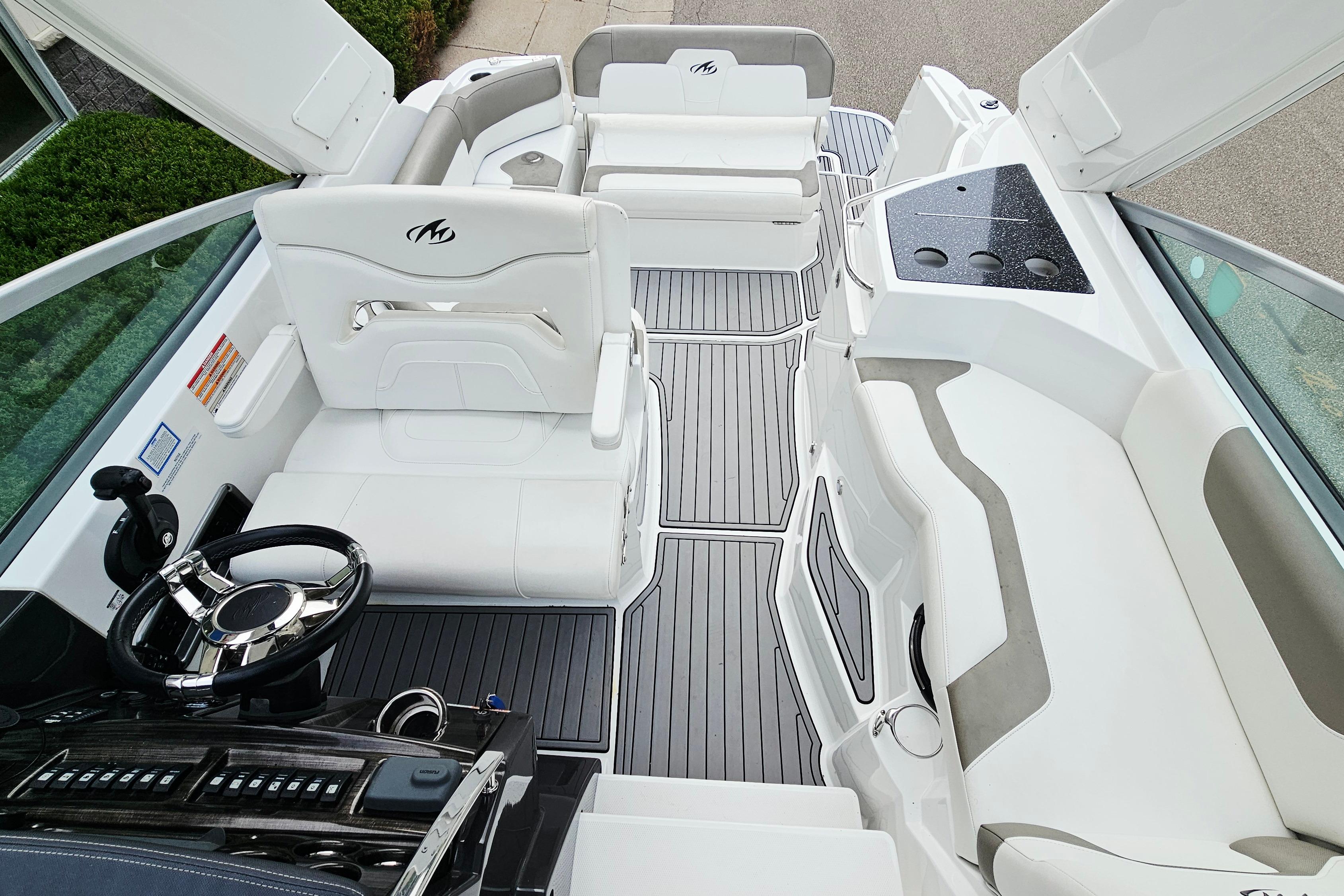 2016 Monterey 295 Sport Yacht interior with sleek white seating and modern helm controls.