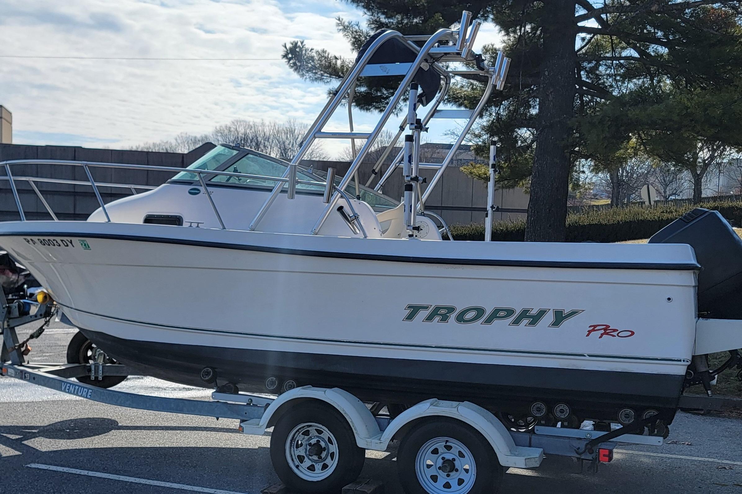 2003 Trophy 2002 Walkaround boat on trailer, parked outdoors.