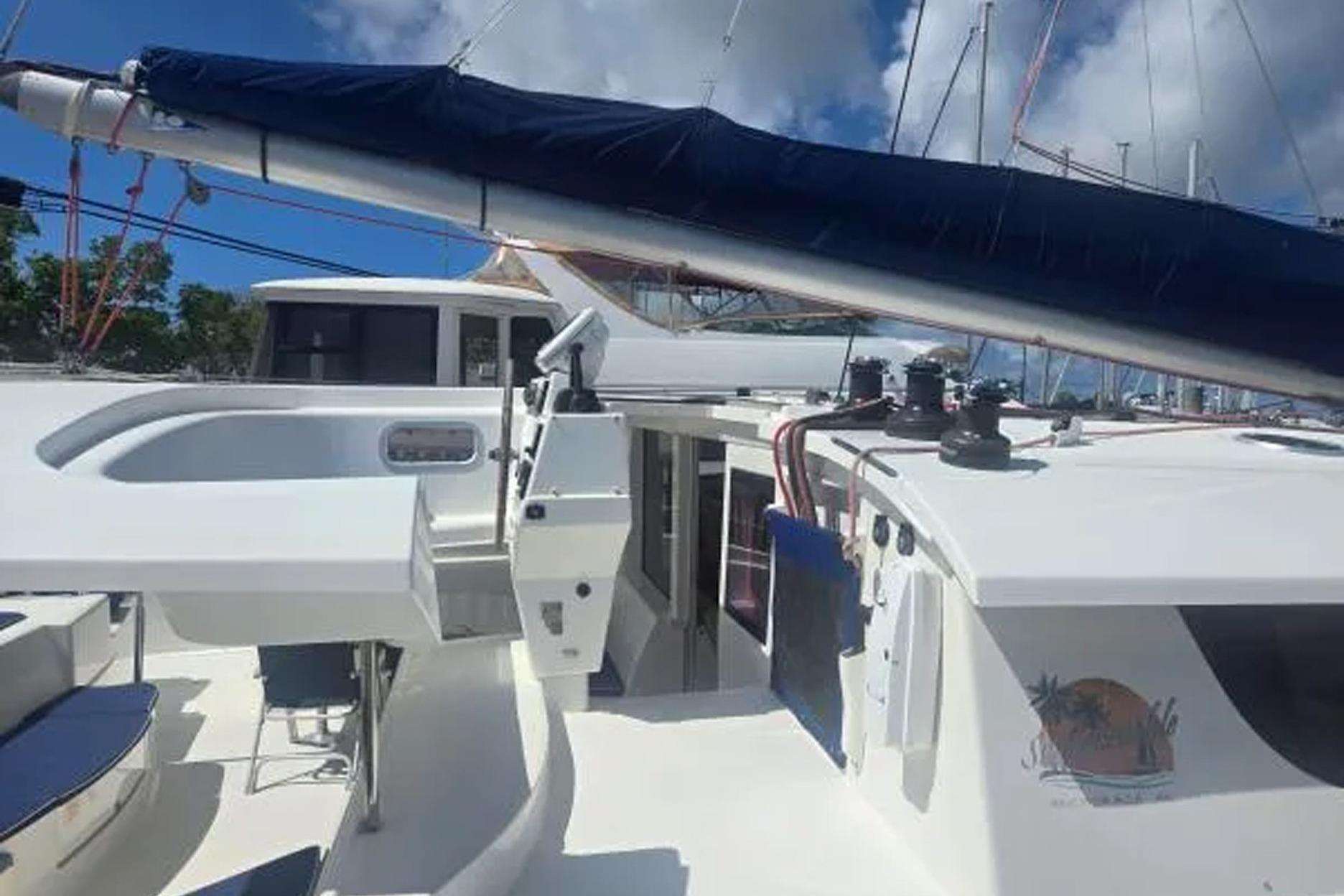 2008 Fountaine Pajot Salina 48 catamaran deck with sail and cockpit view.