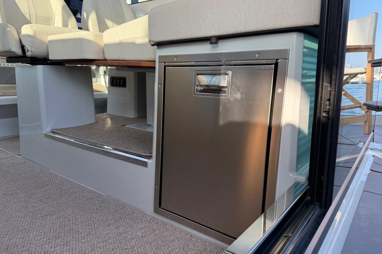 2024 Saxdor 320 GTC interior with seating and built-in stainless steel fridge.