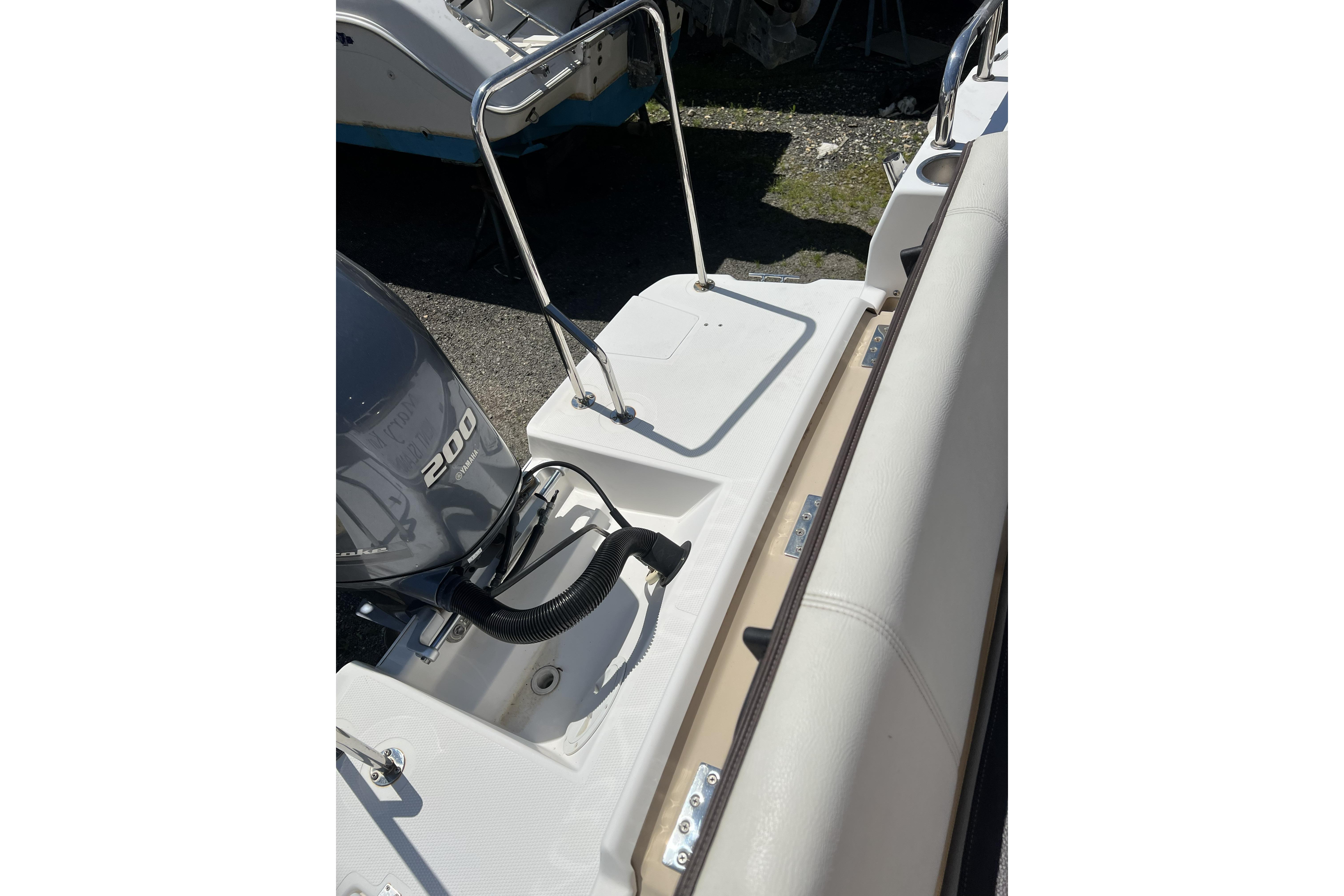 2018 Ranger Tugs R-23 boat with 200 horsepower engine, featuring a sleek deck design.