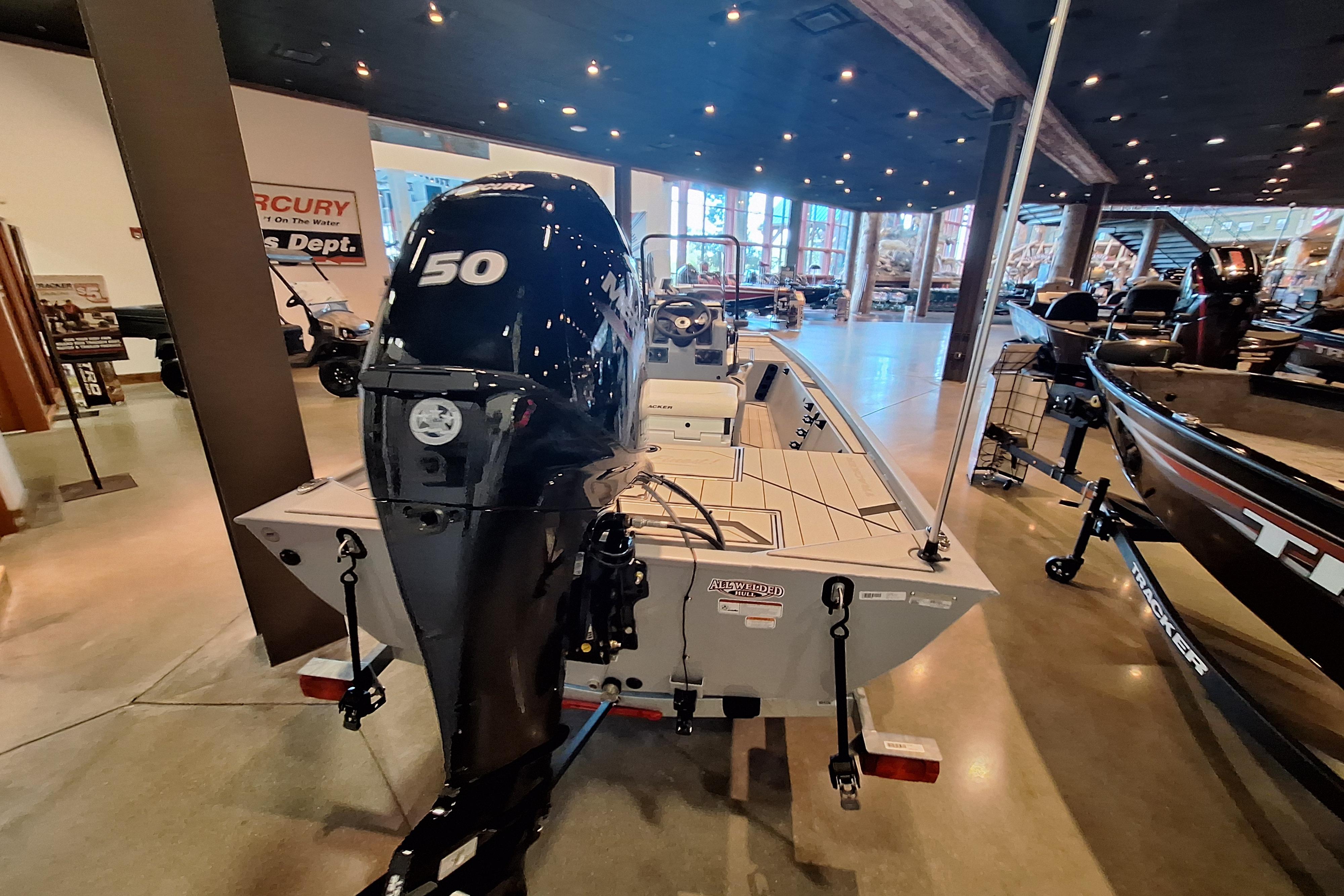 2026 Tracker Bass Tracker Classic CC boat with 150 HP engine displayed indoors.