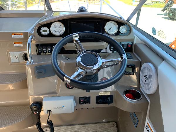 The image shows the helm of a 2017 Regal 26 Express boat with various instruments and a steering wheel.