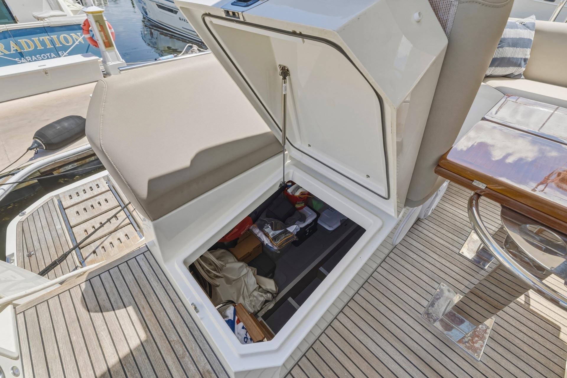 Open storage compartment on 2022 Prestige 520 yacht, showcasing organized interior space.
