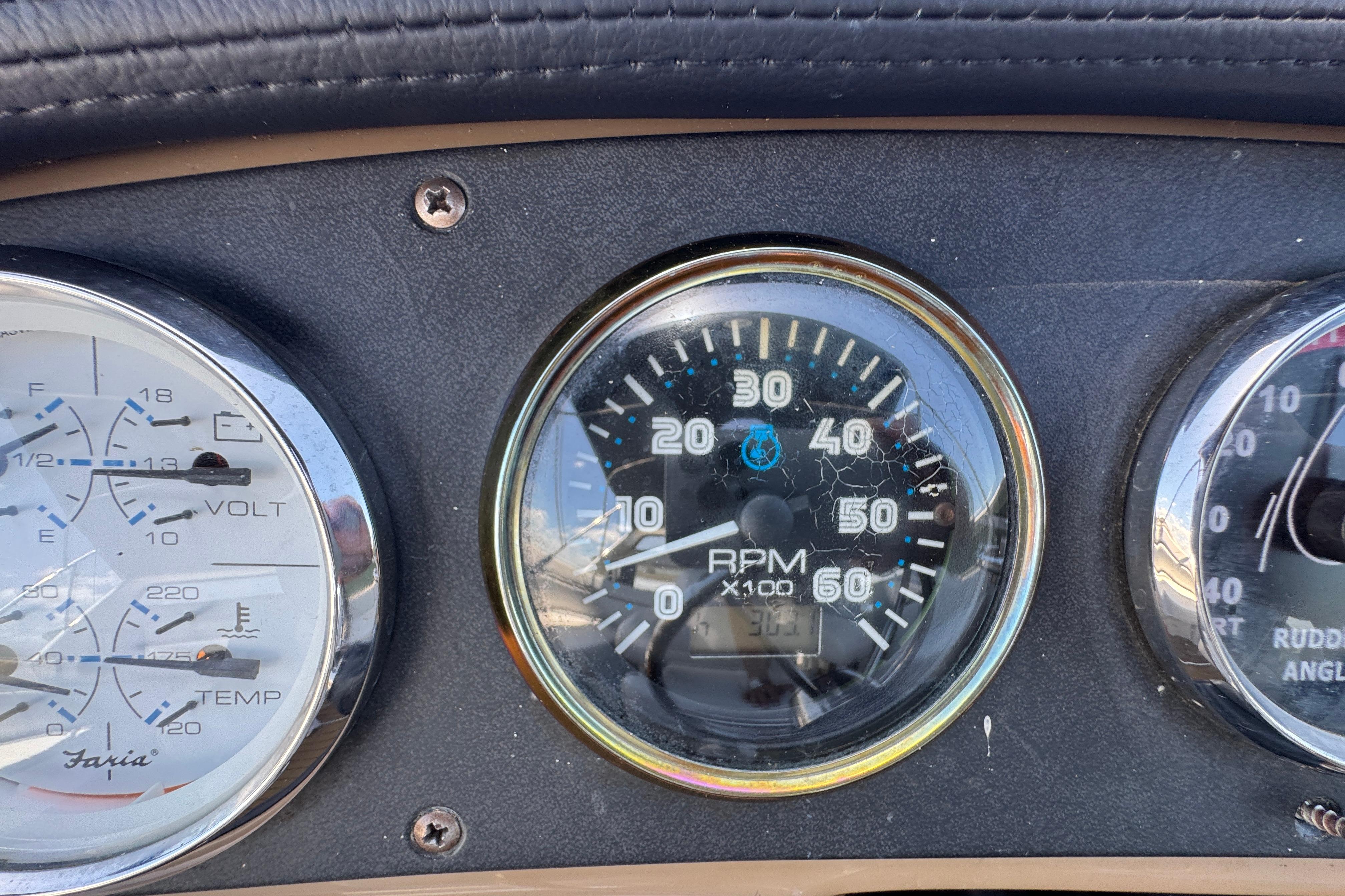 Dashboard gauges of a 2002 Carver 396 Motor Yacht, showing RPM and voltage.