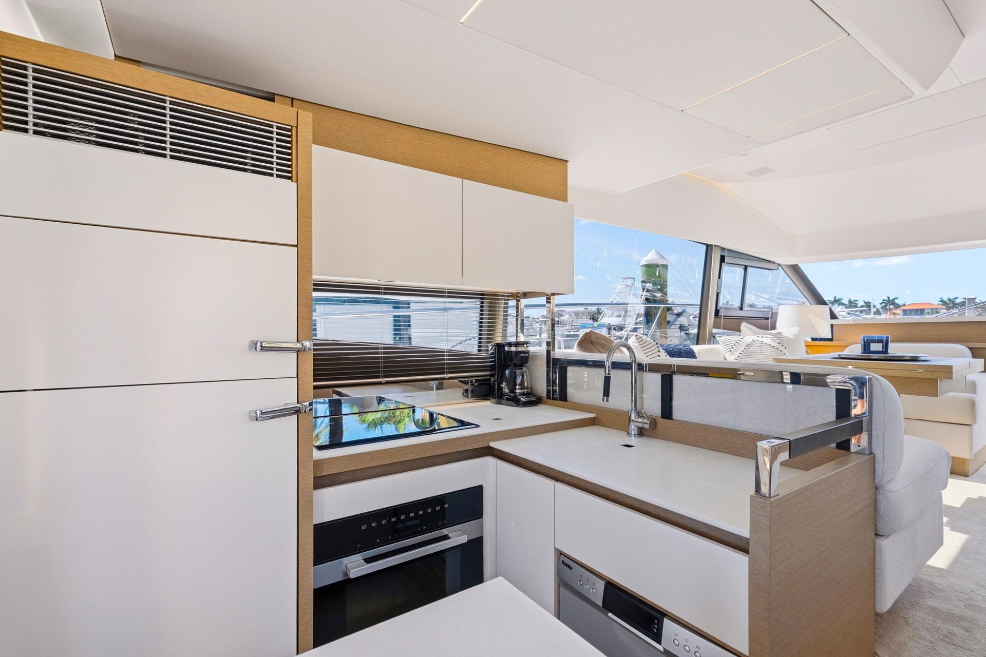 Modern kitchen interior on 2022 Prestige 520 yacht, featuring sleek design and ocean views.