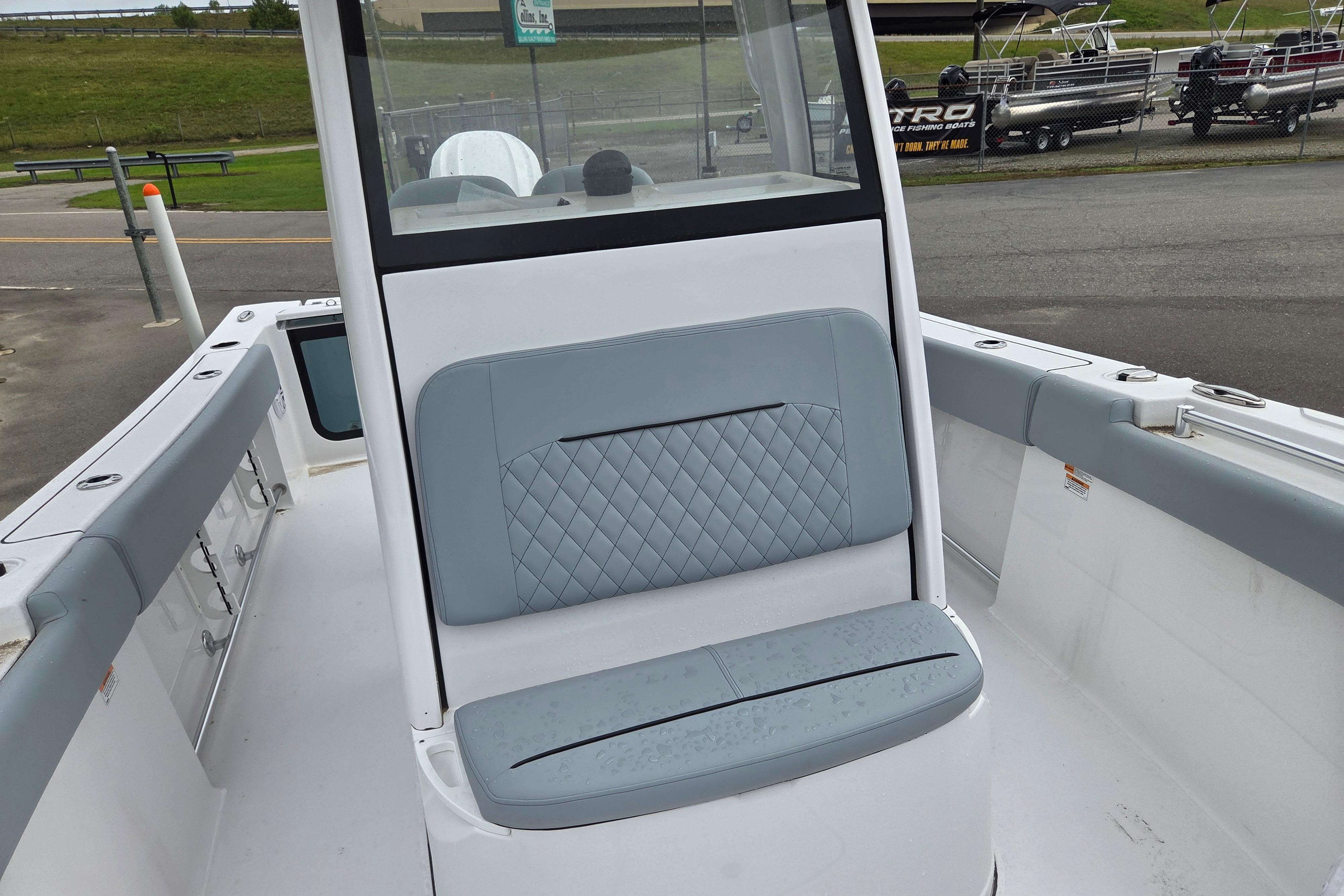 2026 Sportsman Open 232 Center Console boat with cushioned seating and sleek design.