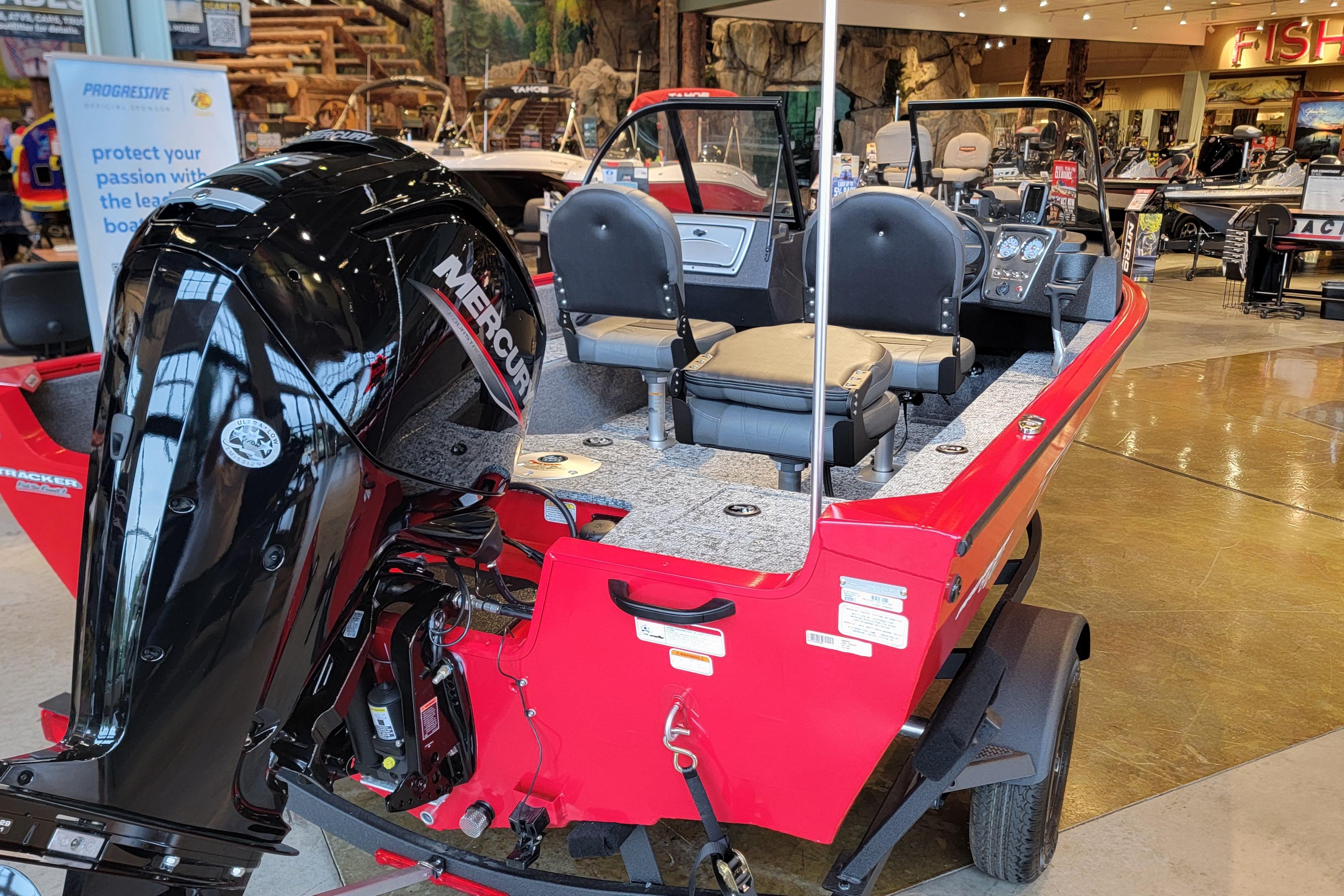 2026 Tracker Pro Guide V-16 WT boat with Mercury engine in showroom.