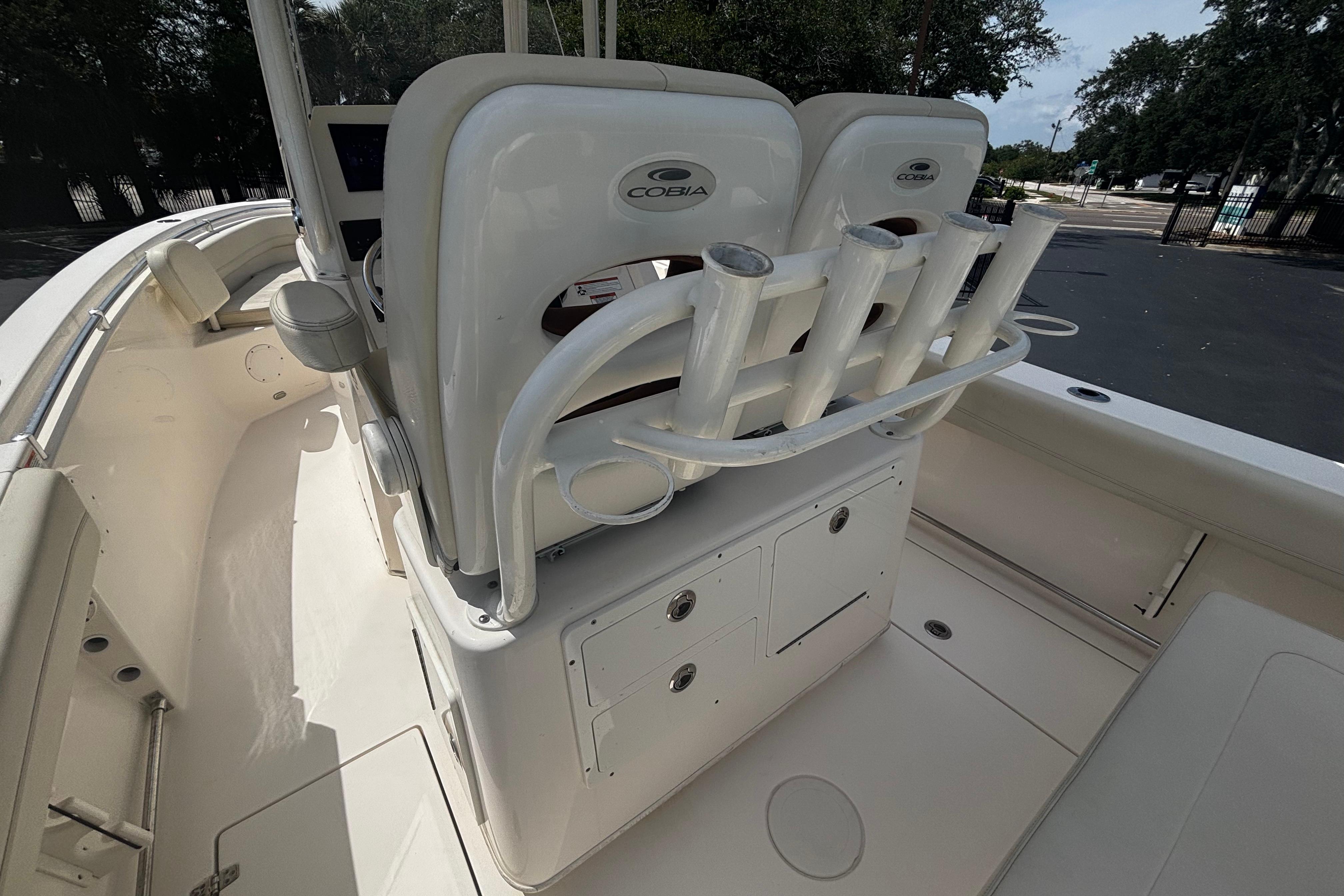 2023 Cobia 262 Center Console boat interior with rod holders and seating.