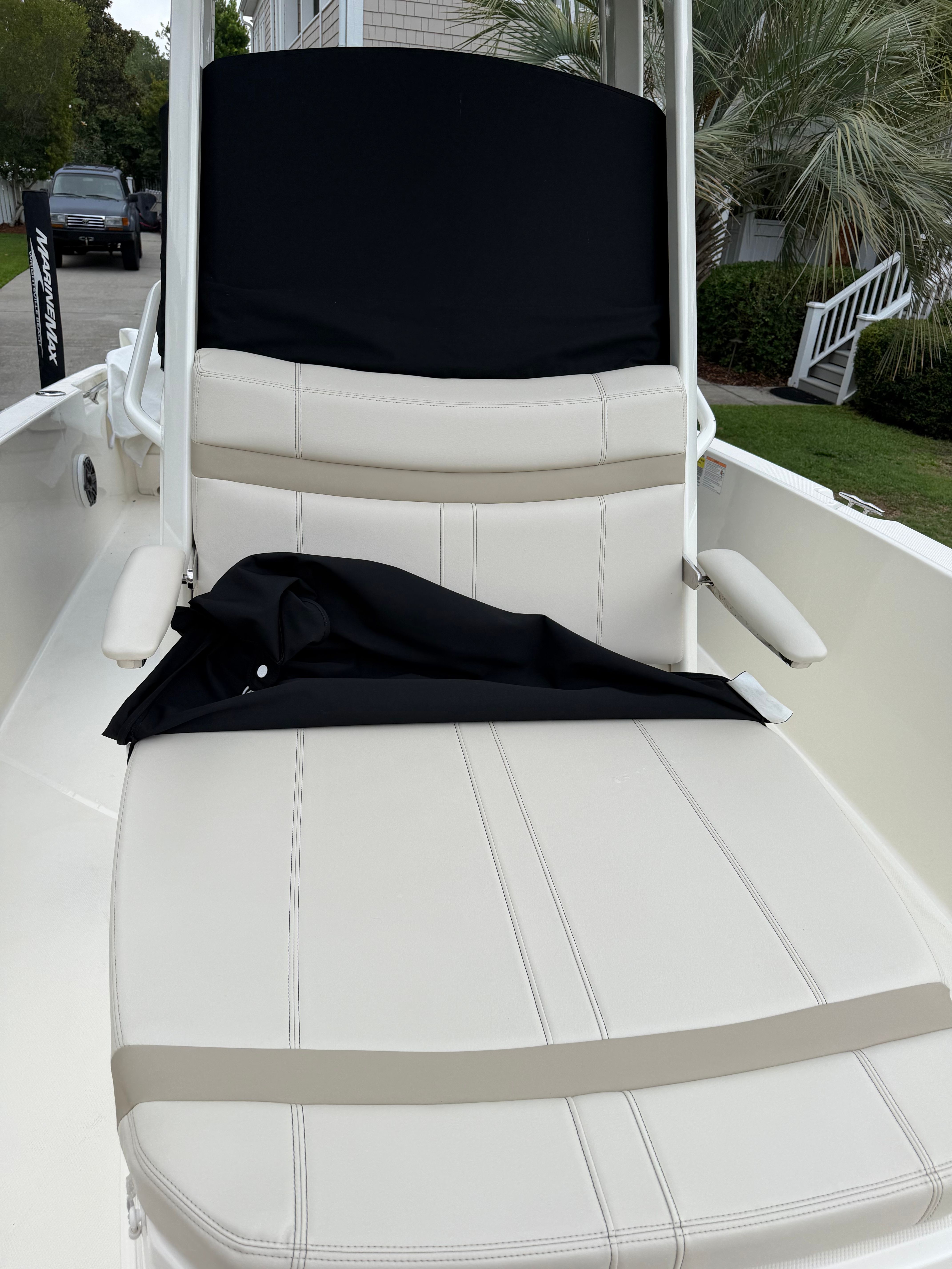 The 2025 Boston Whaler 220 Dauntless features a cushioned bench seat with armrests.