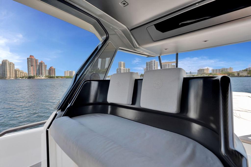 Interior view of 2021 Bluegame BG 42 yacht with city skyline in background.