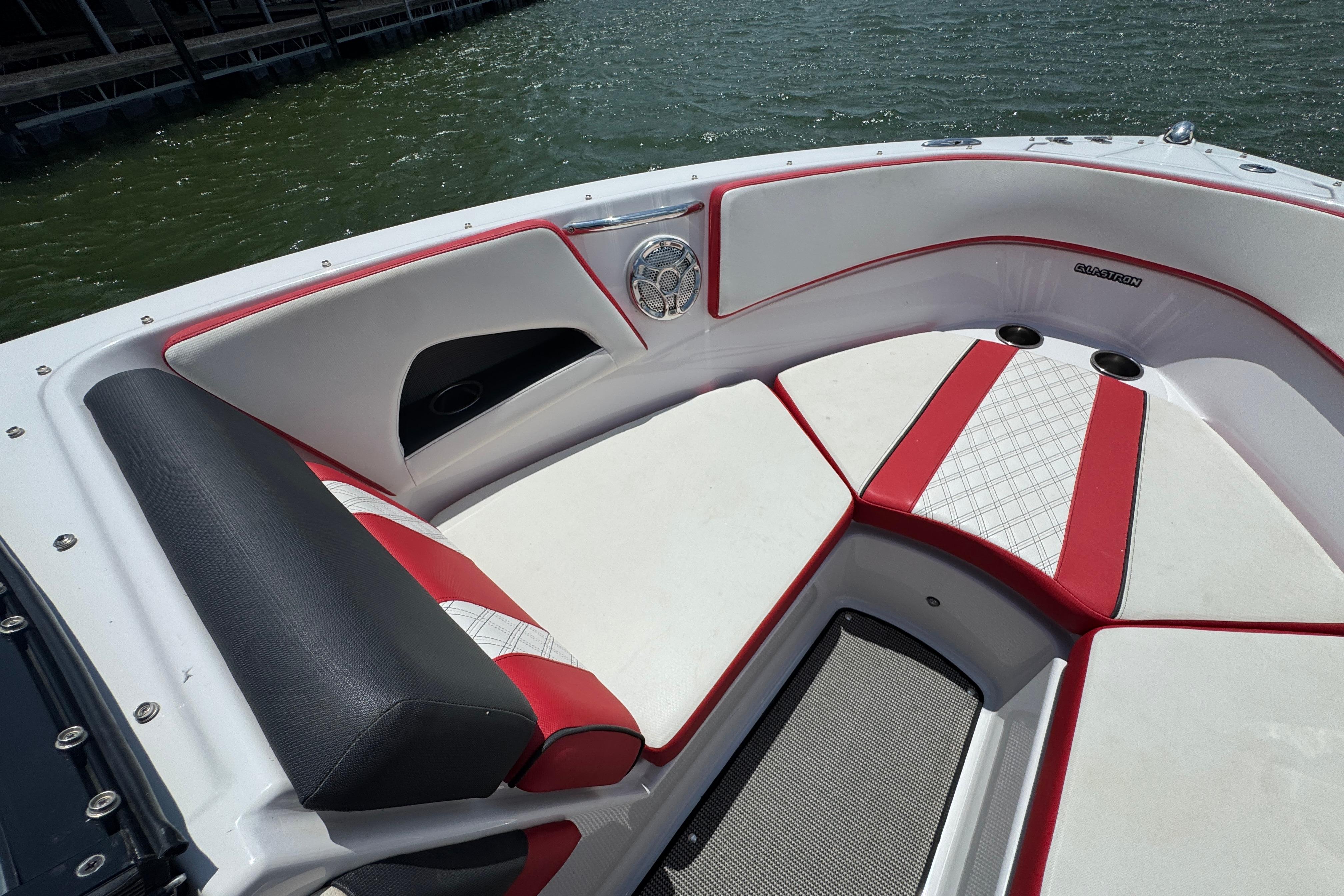 2017 Glastron GT 225 boat interior with red and white seating, on a sunny day.