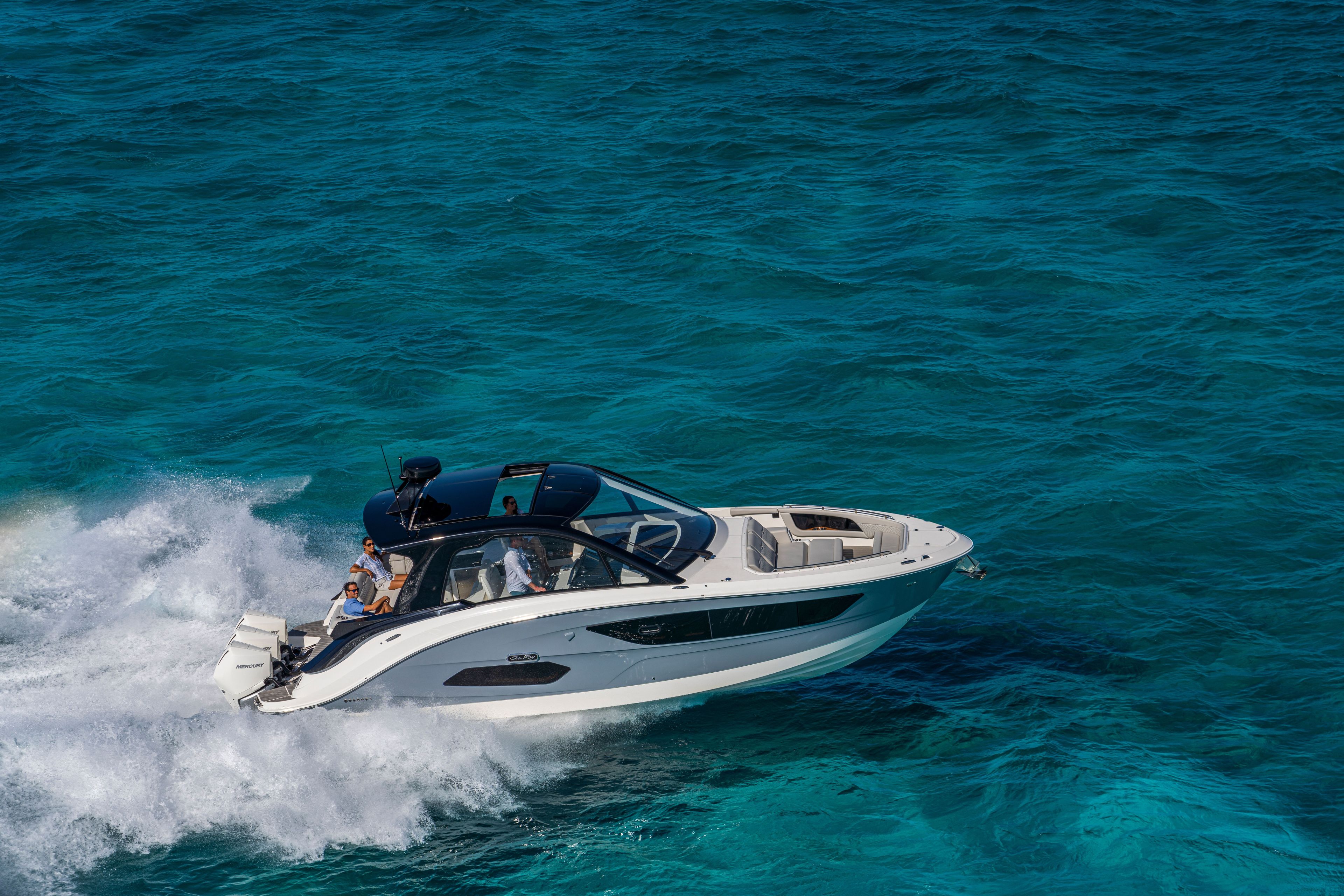 Sea Ray Sundancer 370 Outboard from 2026 gliding over turquoise water.