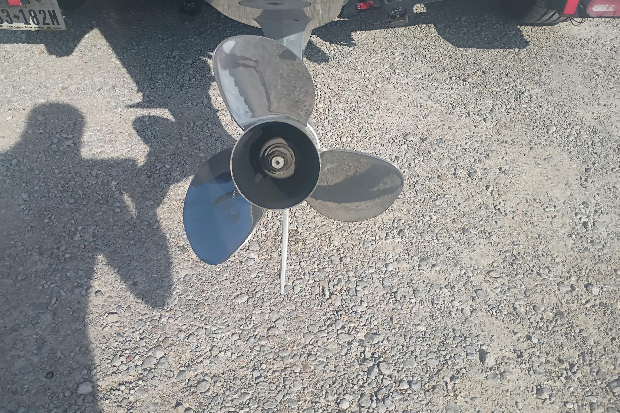 2024 iKon LX21 boat propeller on gravel surface, casting shadow.