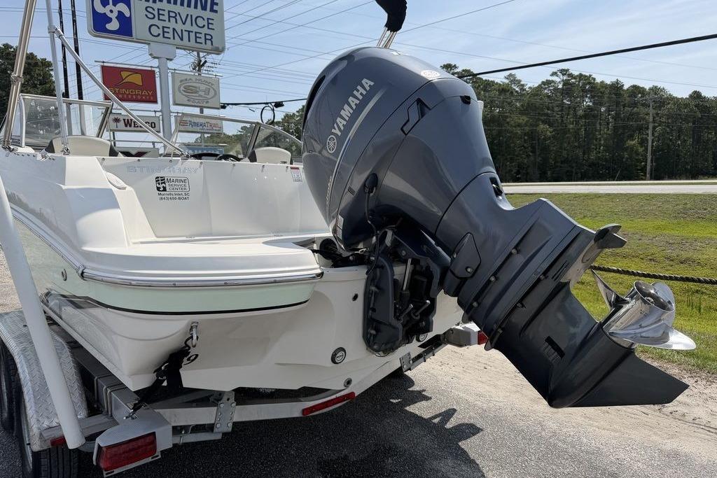 2019 Stingray 201 DS boat with Yamaha outboard motor at marine service center.