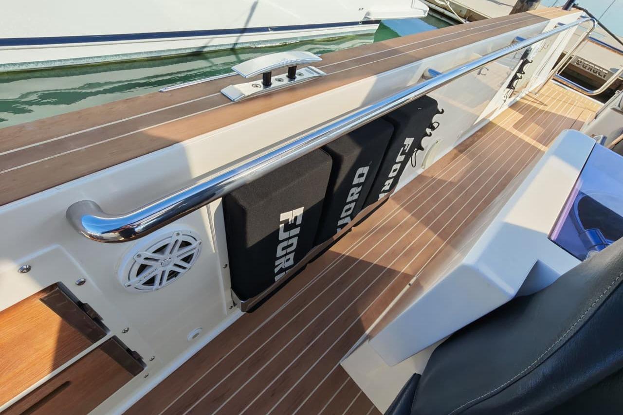 2015 Fjord 40 Open boat deck with teak flooring and branded accessories.