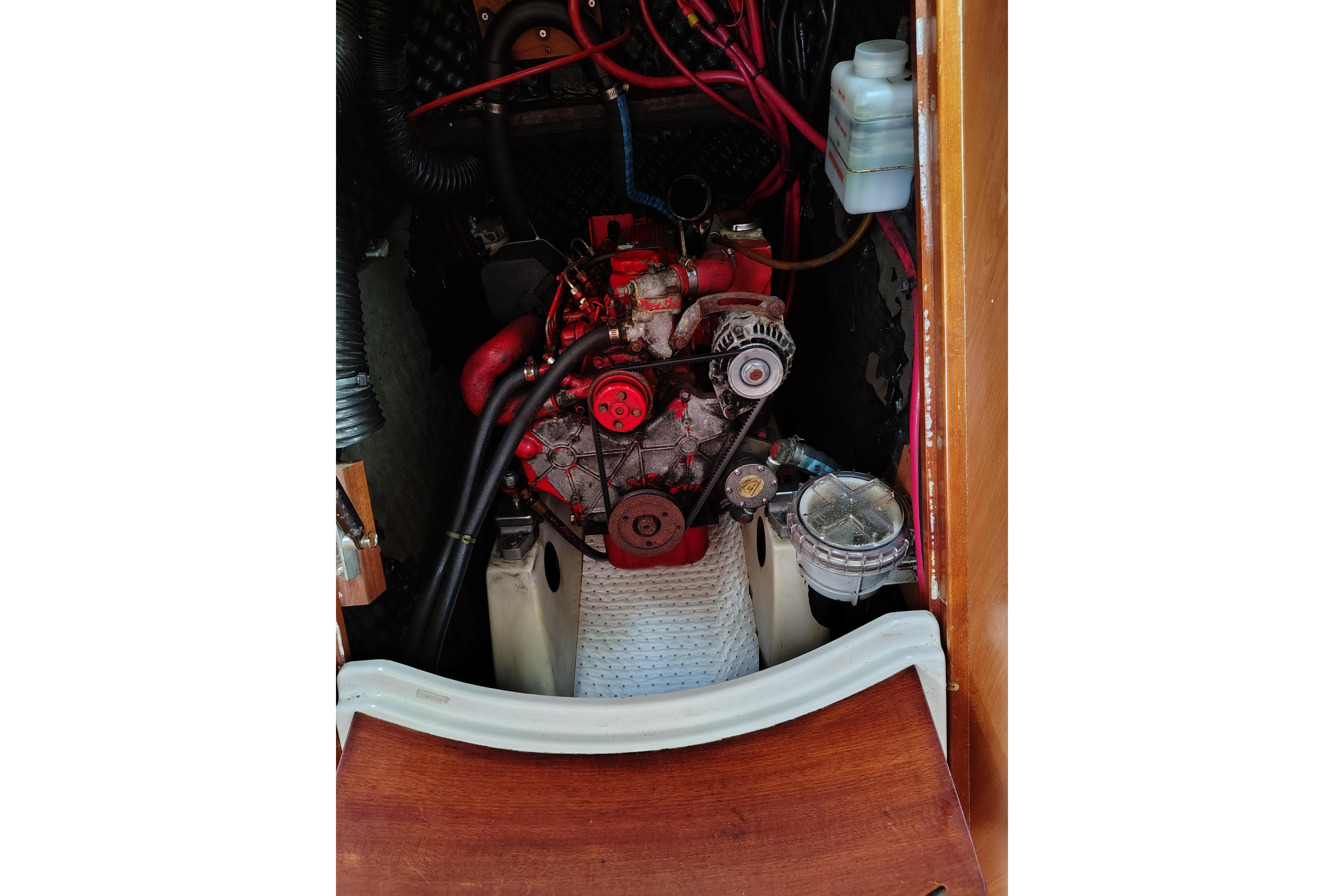 Engine compartment of a 2001 Beneteau Oceanis 411 sailboat, showcasing mechanical components.