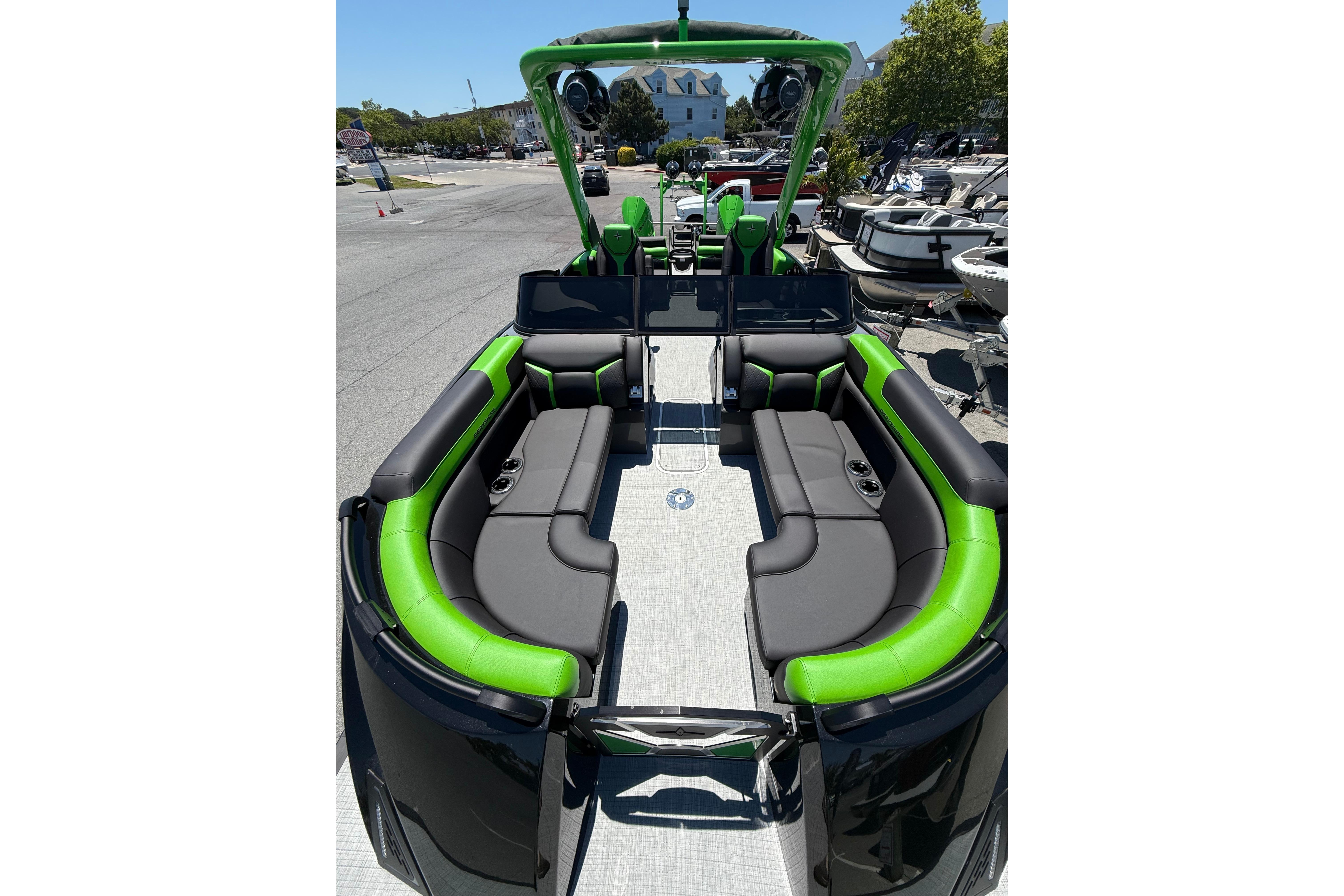 2026 Berkshire Sport SLX9 DC boat with sleek black and green seating, docked outdoors.