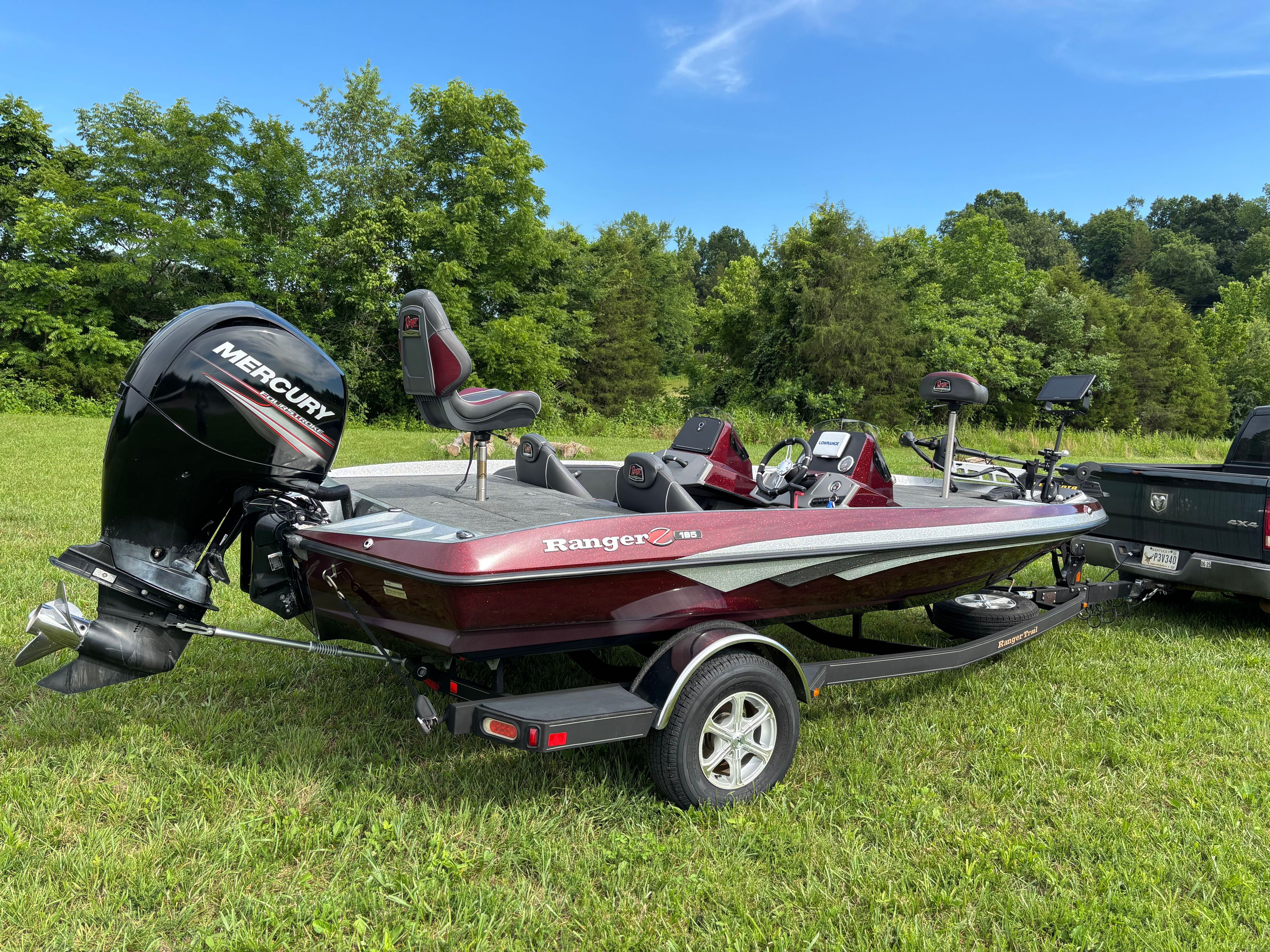 A 2016 Ranger Z 185 boat on a trailer in a grassy area.