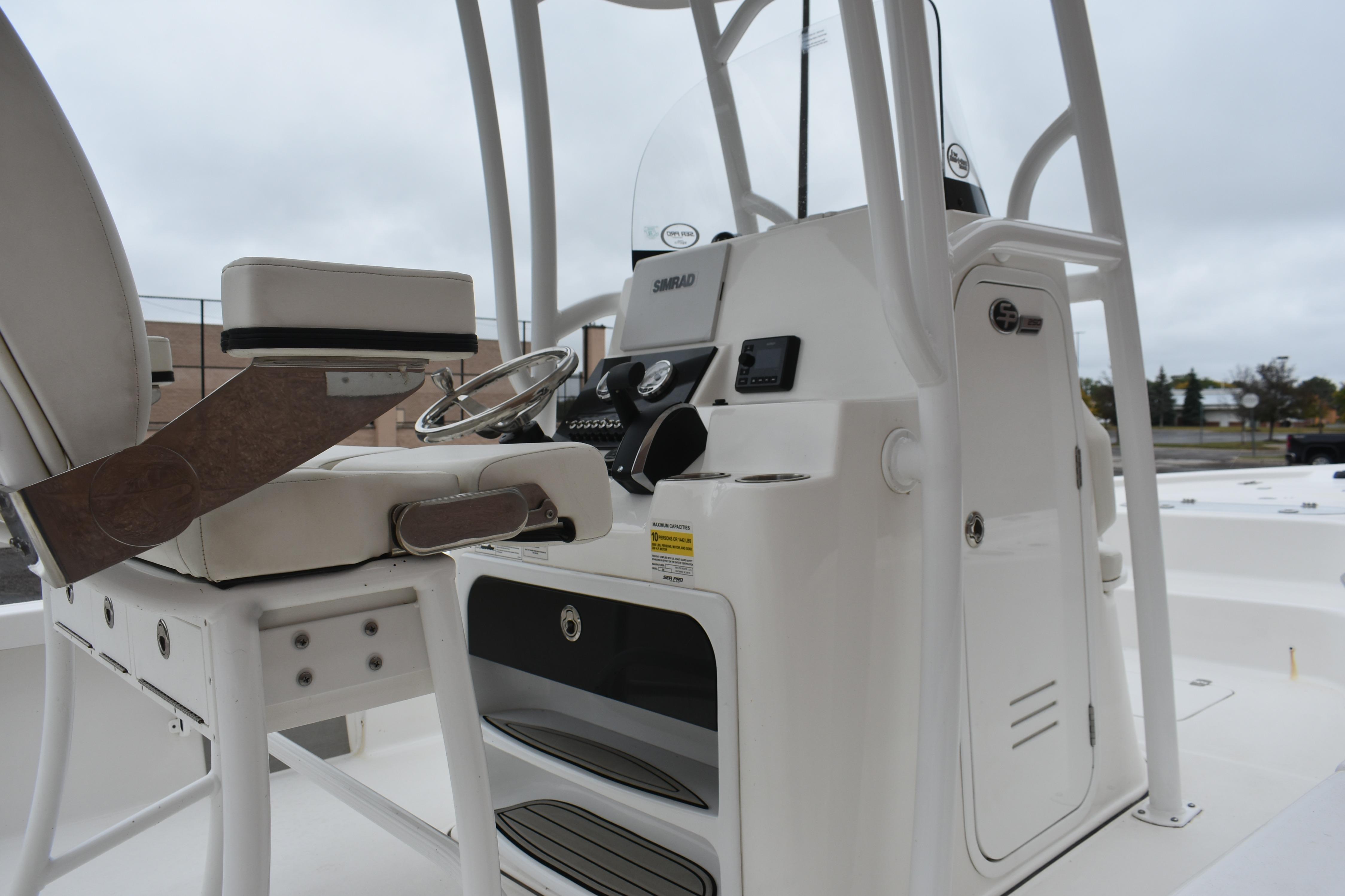 2025 Sea Pro 250 Bay boat interior with steering console and seating.