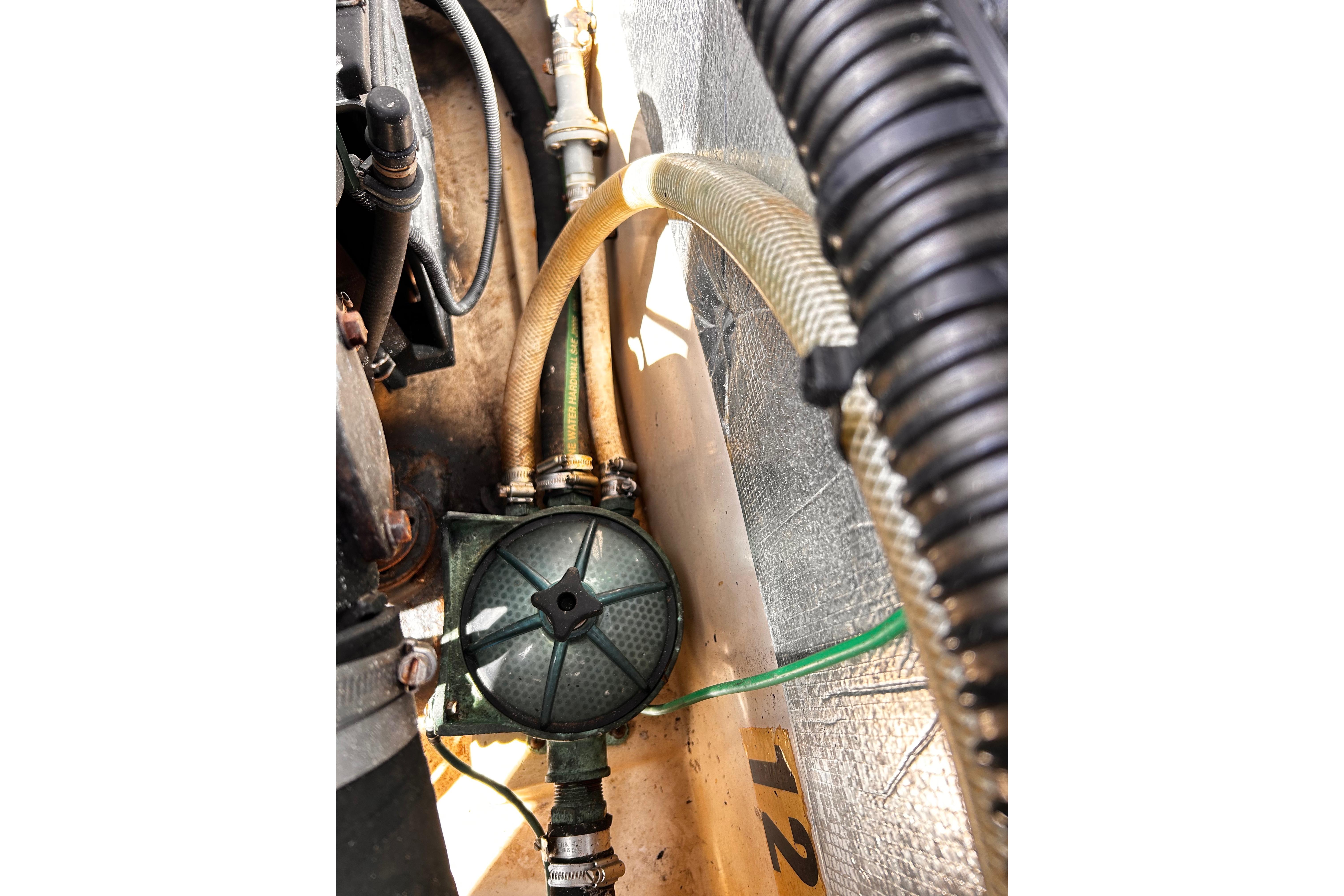 Engine compartment of a 2014 Cutwater C-28 boat showing hoses and mechanical components.