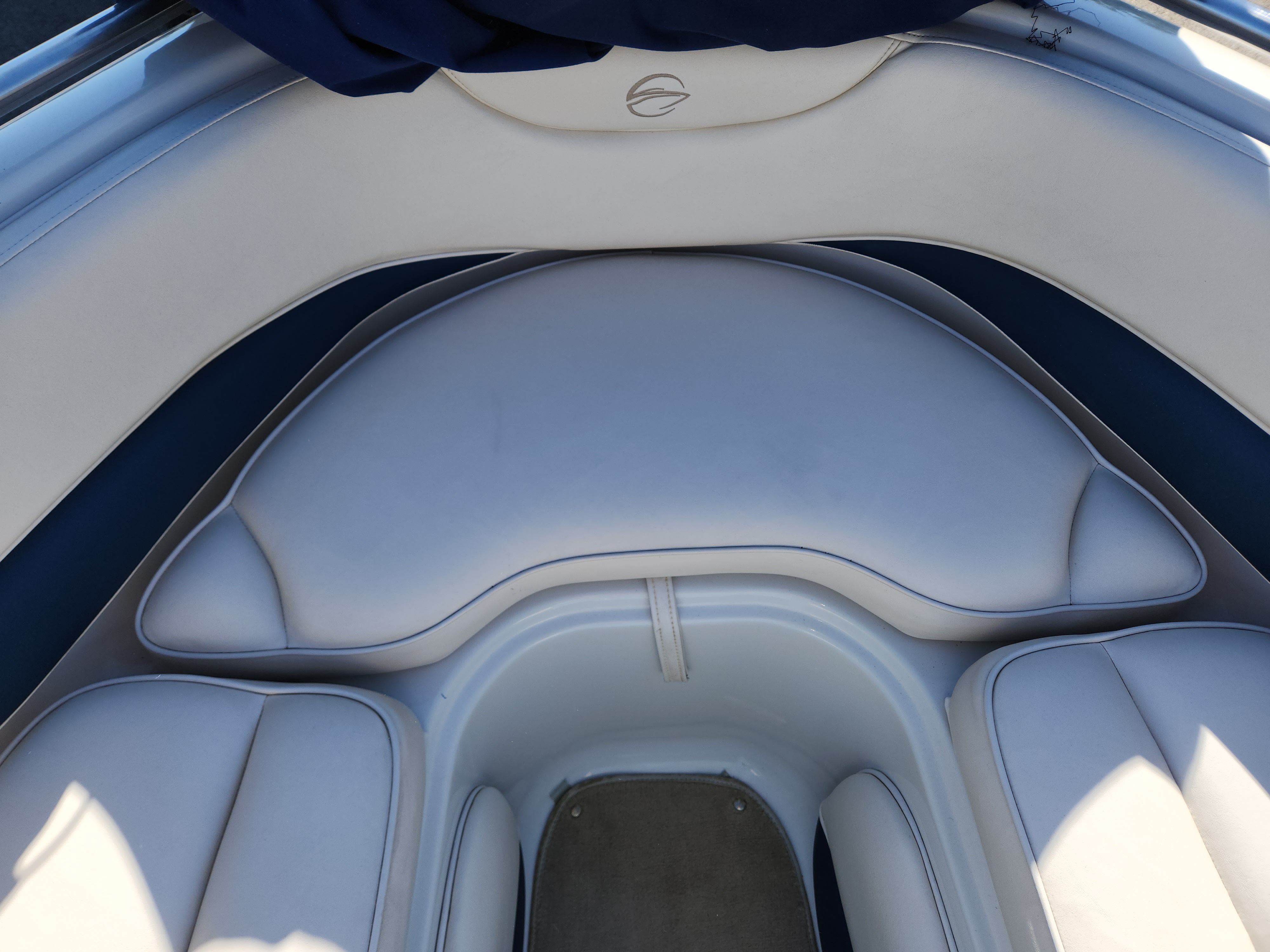 Interior of a 2003 Crownline 225 BR boat with white upholstery.