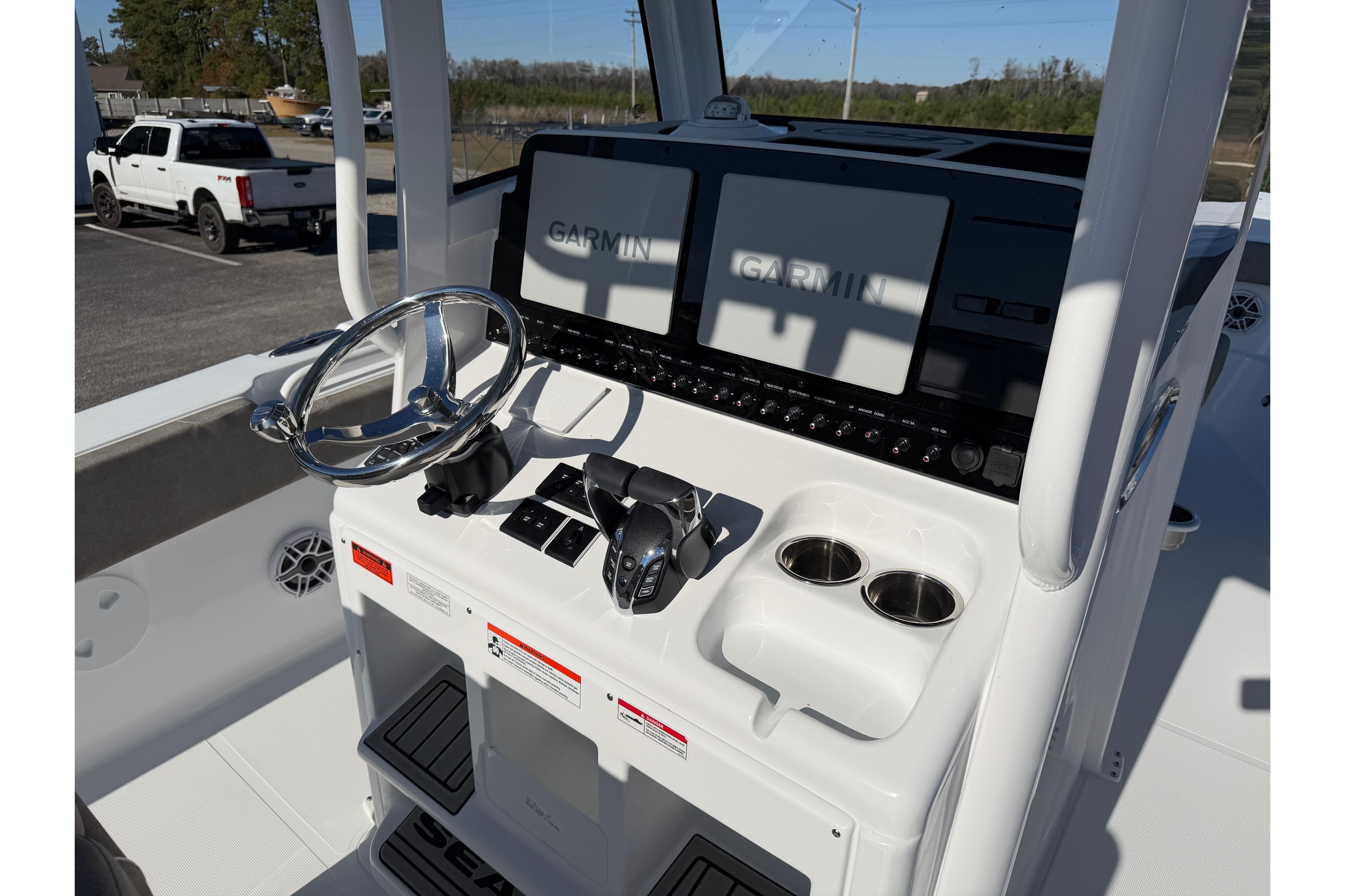 2026 Sea Hunt Ultra 275 Coffin Box boat console with Garmin displays and steering wheel.
