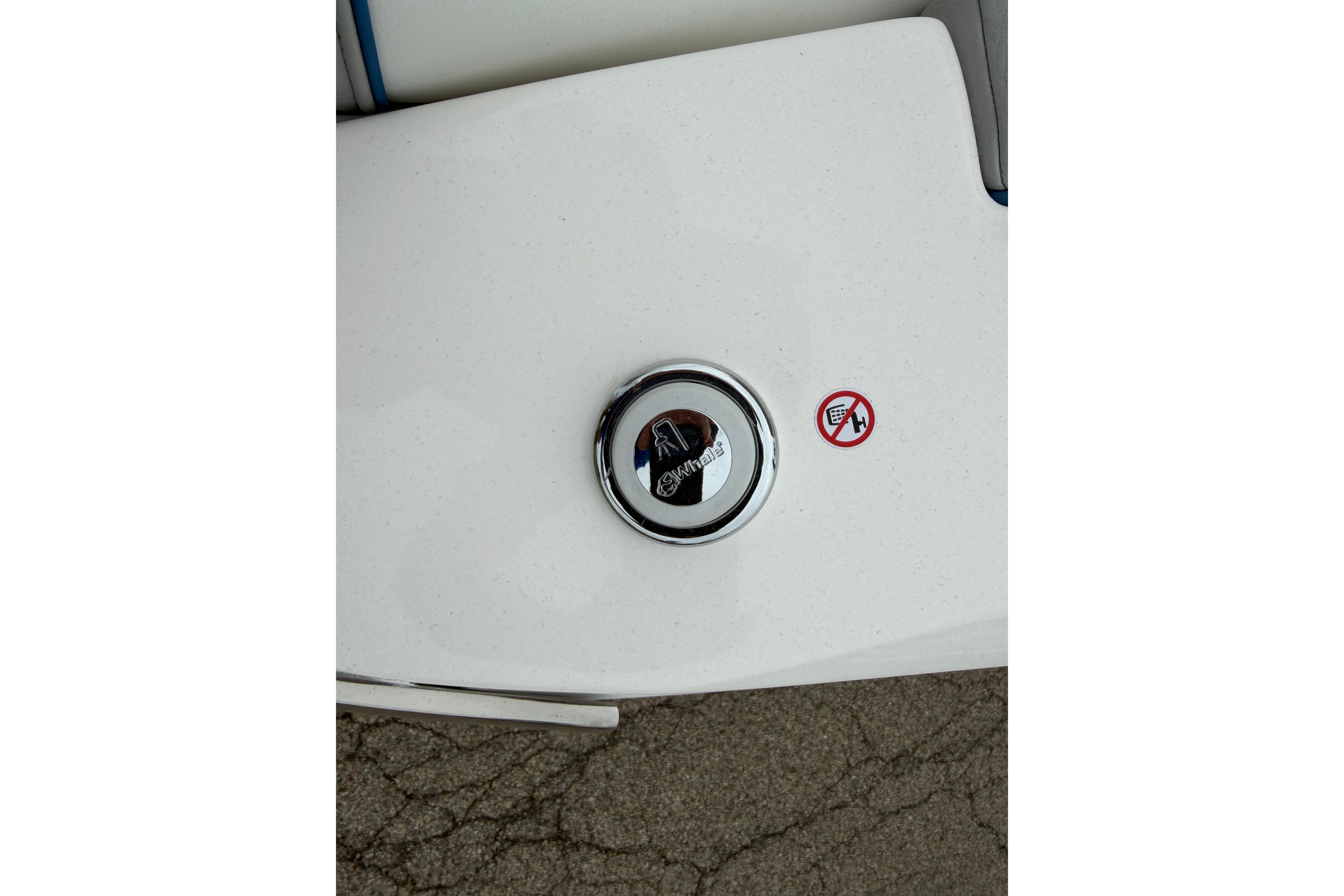 Fuel cap of 2026 Regal LS9 Surf boat with warning sticker on white surface.