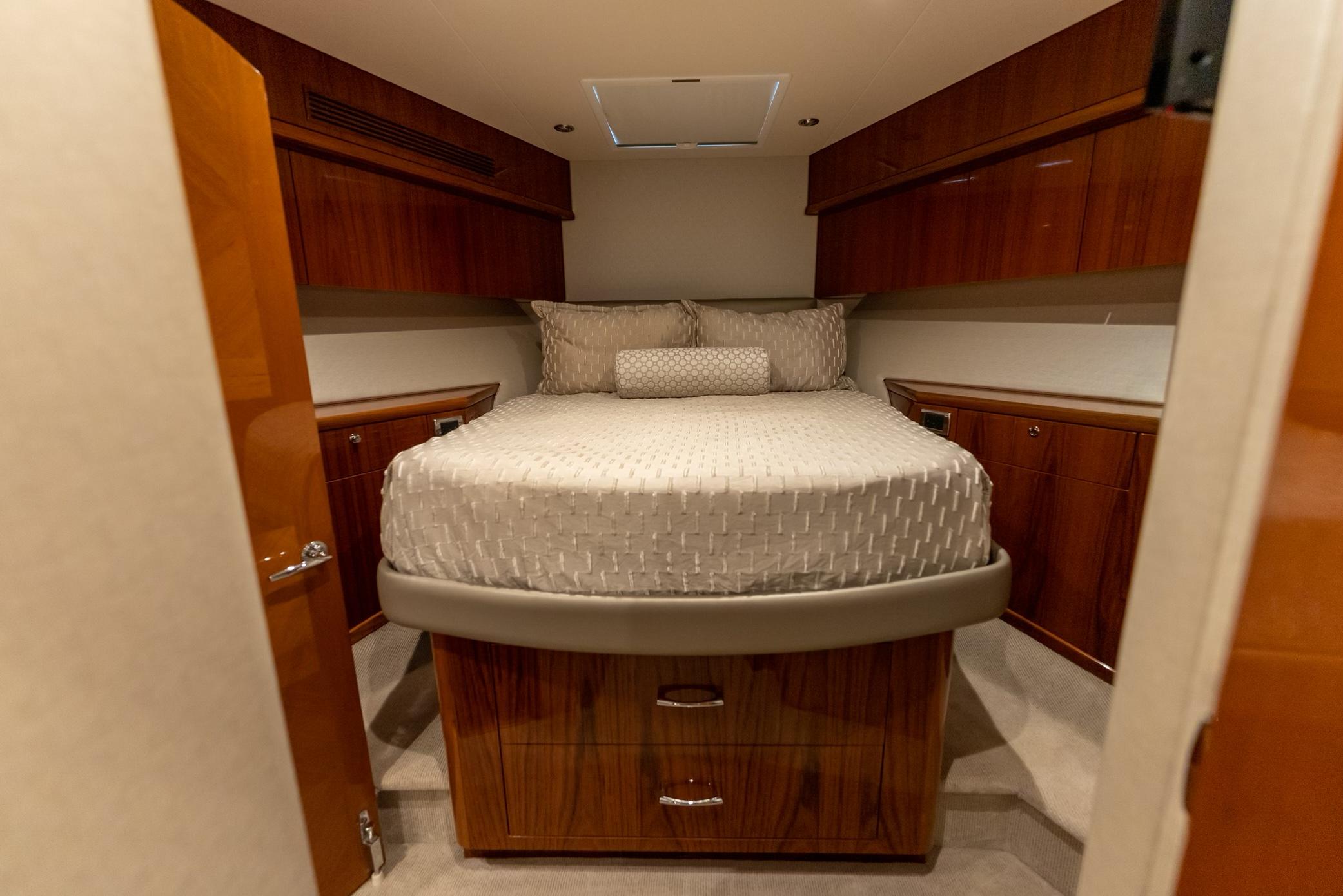 Luxurious cabin interior of 2018 Hatteras GT70 yacht with elegant wood finish.
