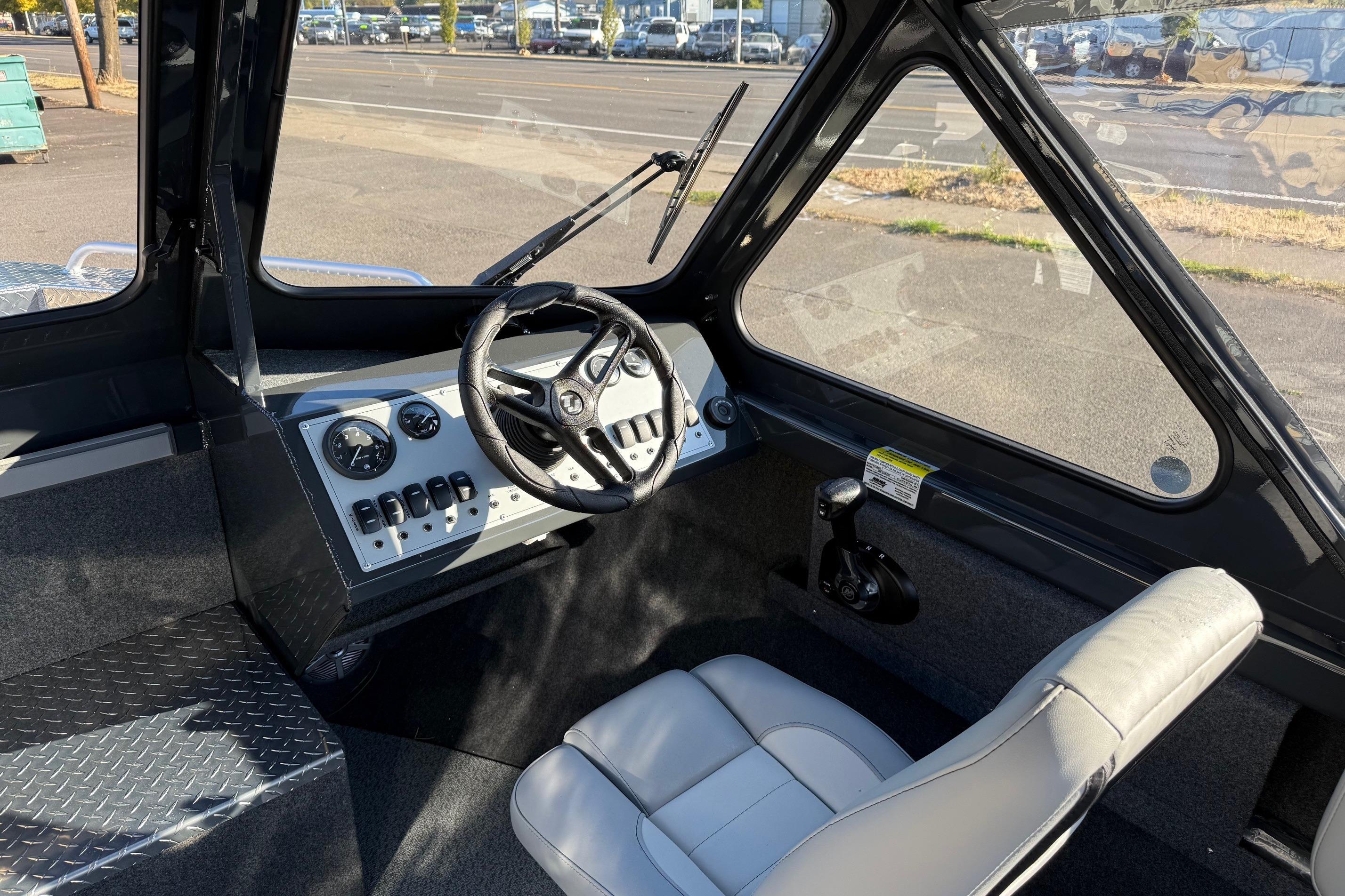 Interior of 2026 Thunder Jet 200 Luxor boat with steering wheel and dashboard controls.