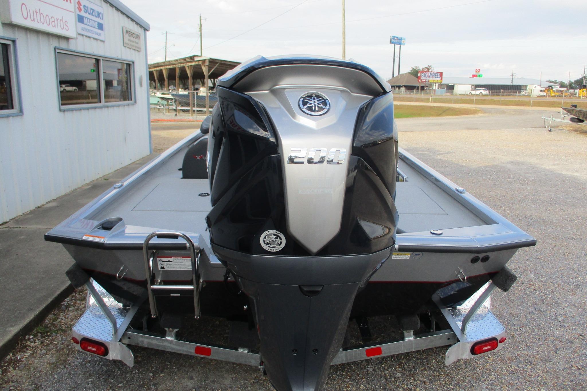 2026 Vexus AVX2080 boat with Yamaha 200 engine, parked outside dealership.