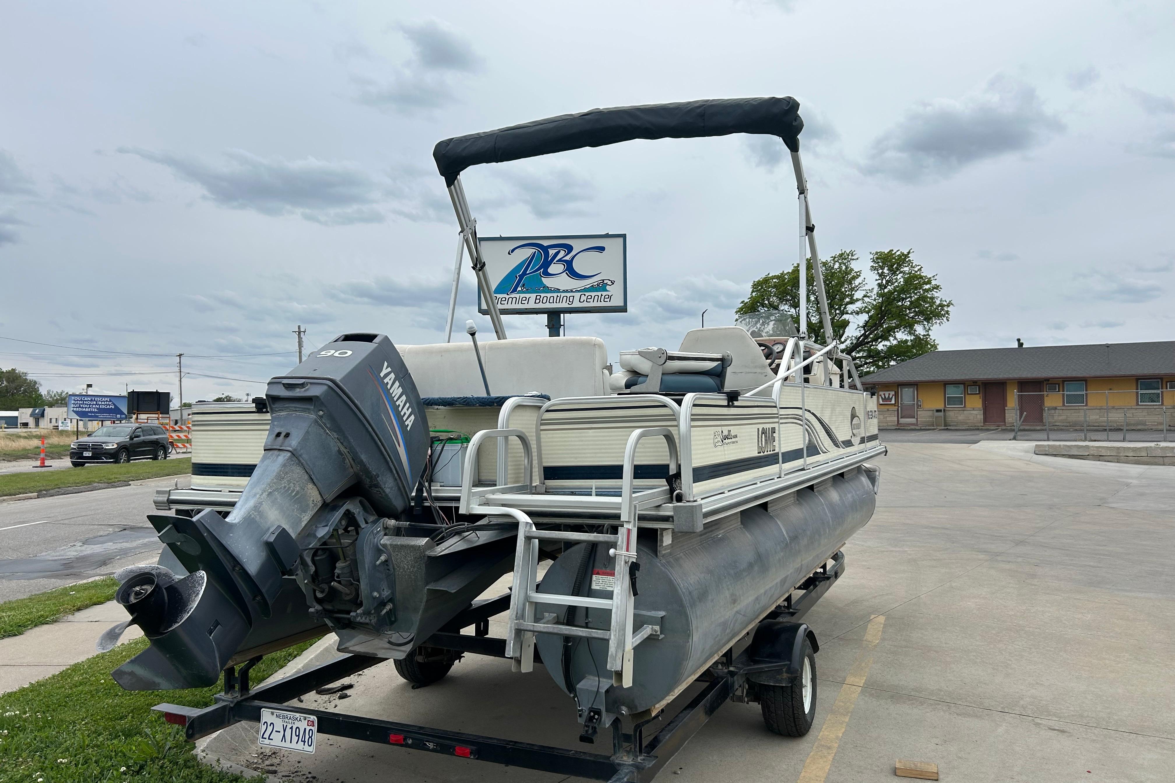 2002 Lowe Trinidad 200 pontoon boat with Yamaha motor on trailer at Premier Boating Center.