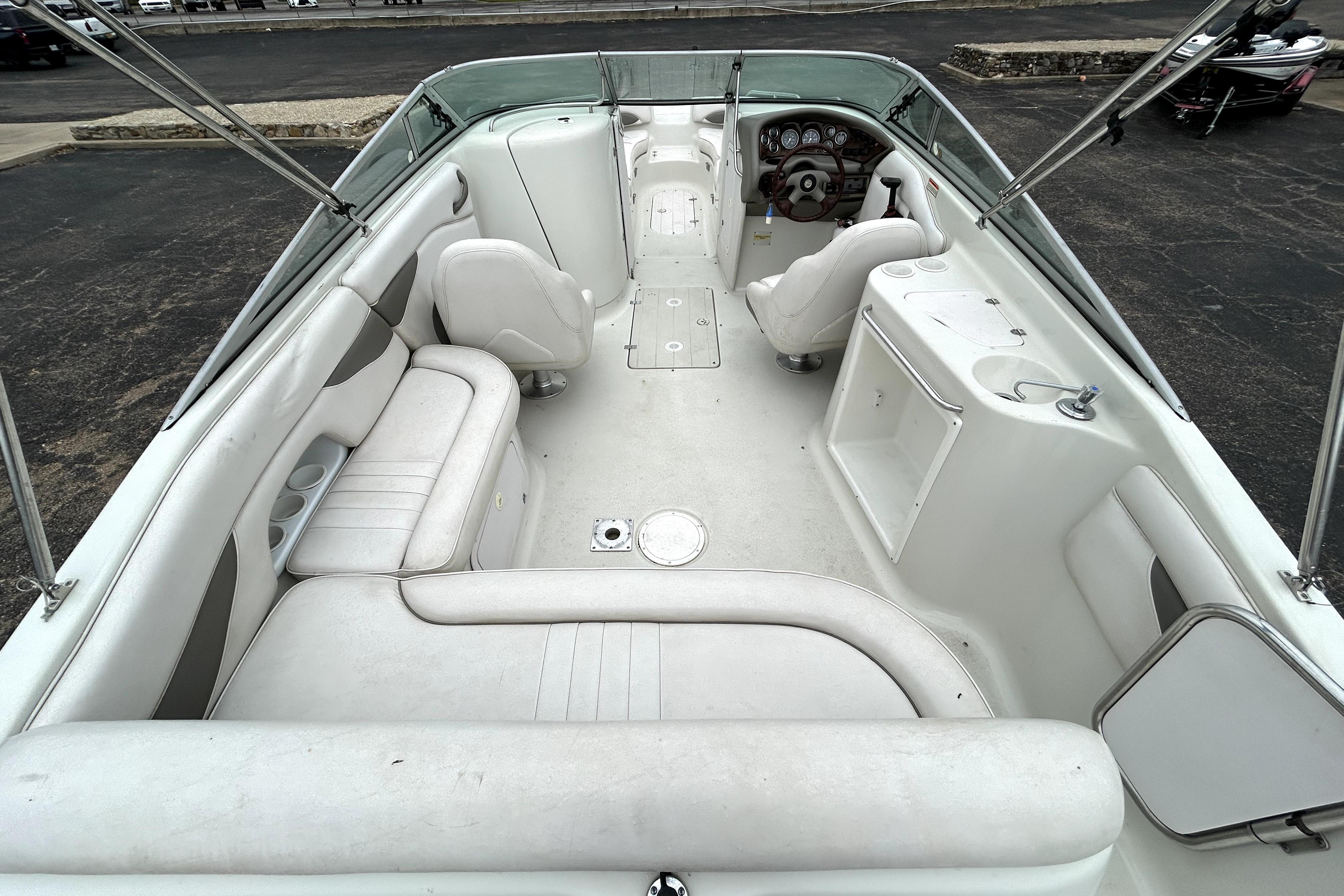 2001 Crownline 239 DB boat interior with white seating and dashboard view.