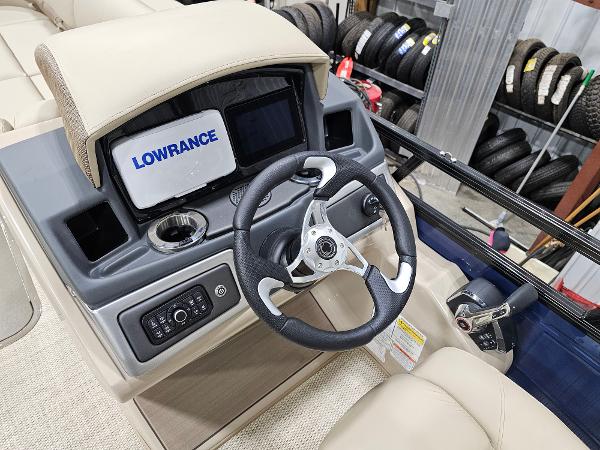 2024 Regency 250 DL3 boat dashboard with Lowrance display and steering wheel.