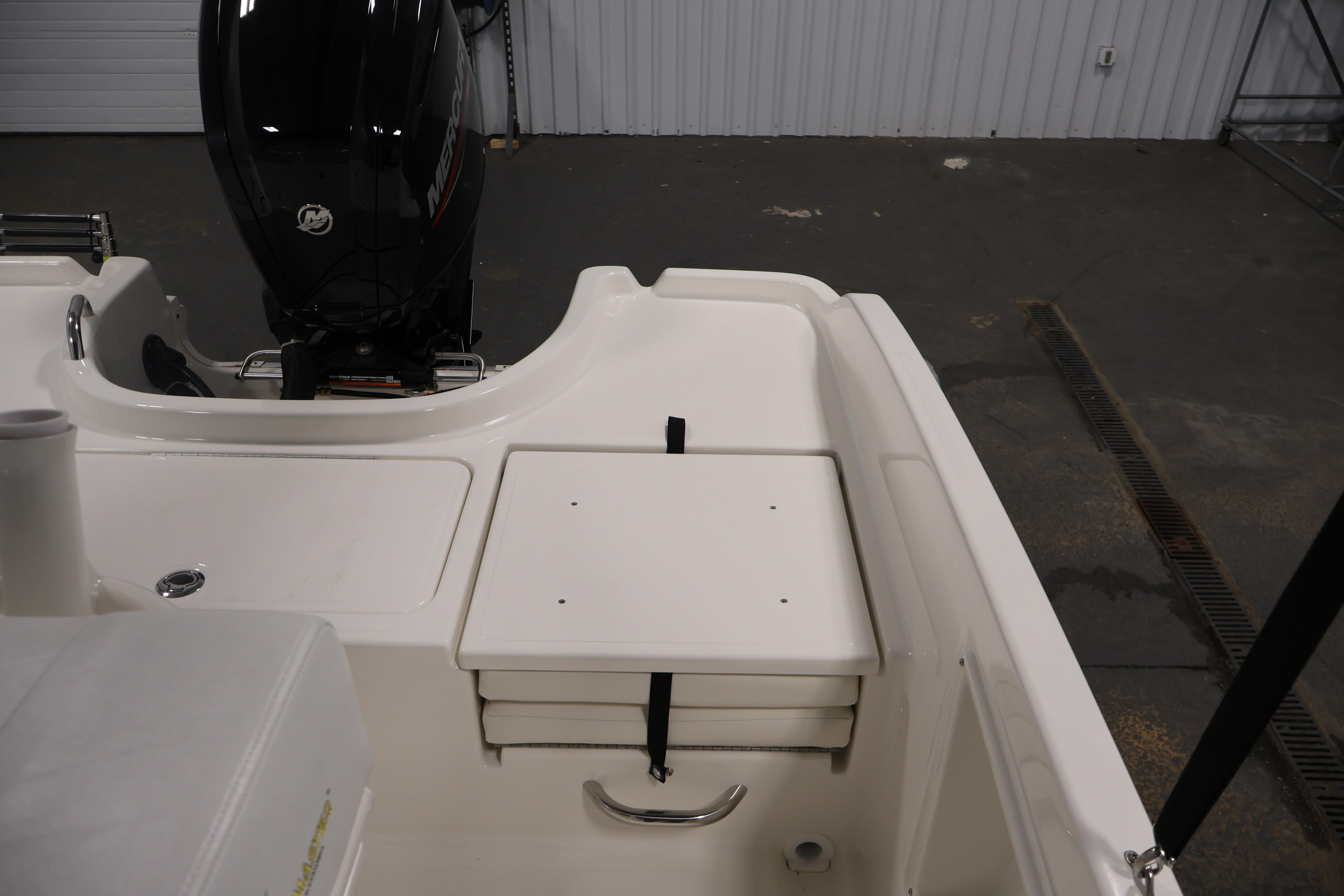 2026 Bayliner Trophy T18 boat interior with Mercury engine, featuring storage compartment.