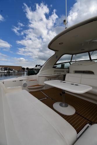 2003 Sea Ray 460 Sundancer yacht with spacious deck and seating under a blue sky.