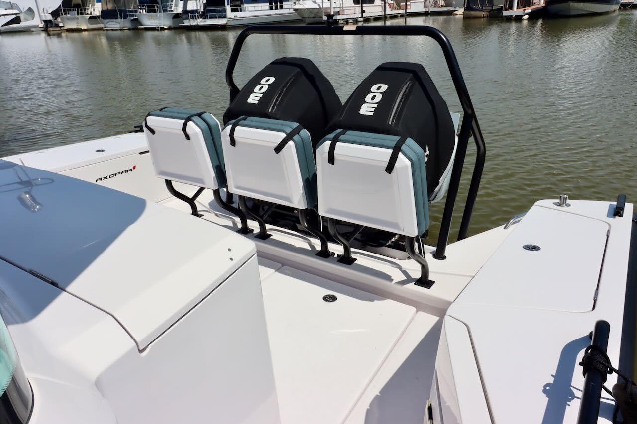 2022 Axopar 37 XC Cross Cabin boat with rear seating, docked at a marina.